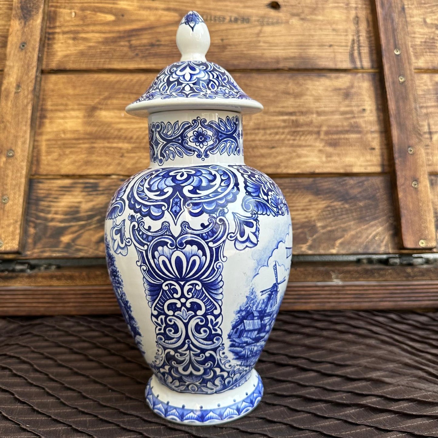 Blue and white decorative vase with intricate patterns on a wooden surface