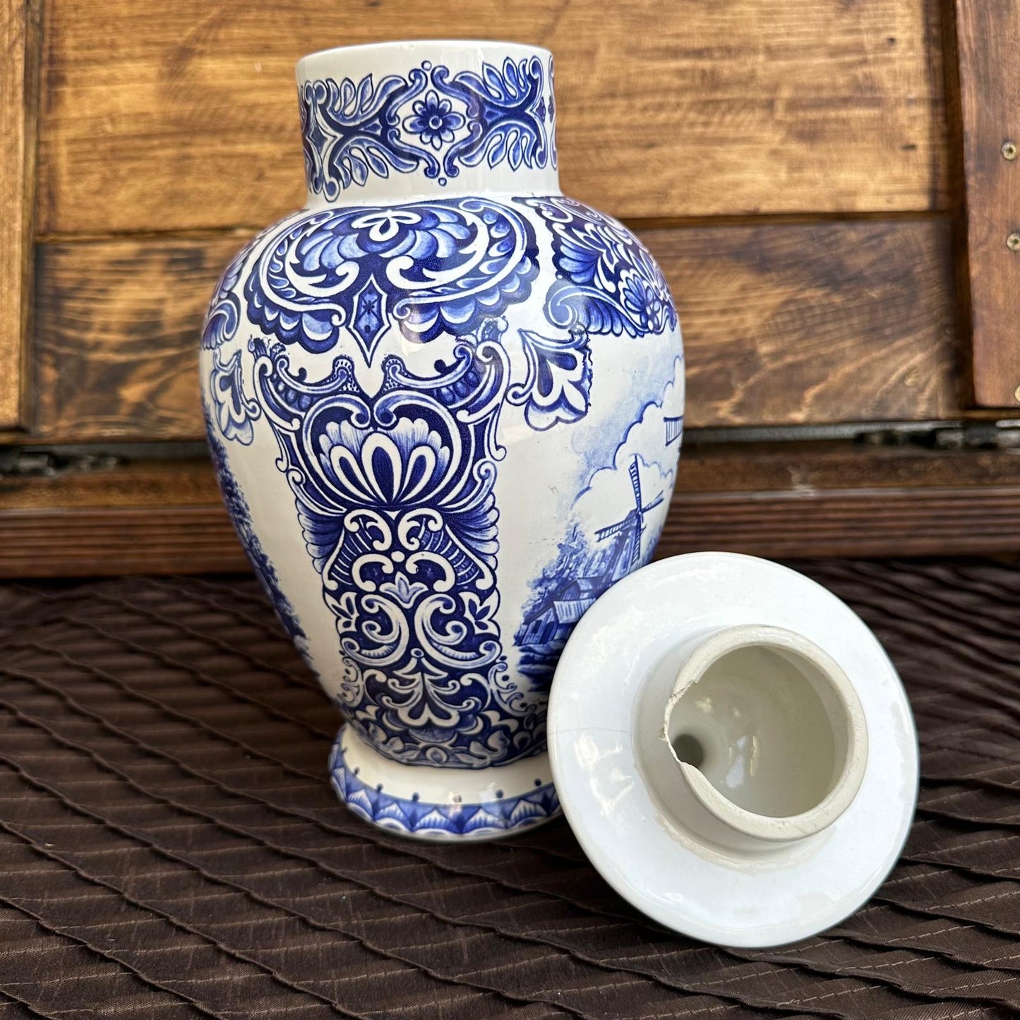Blue and white ceramic vase with intricate patterns on a wooden surface