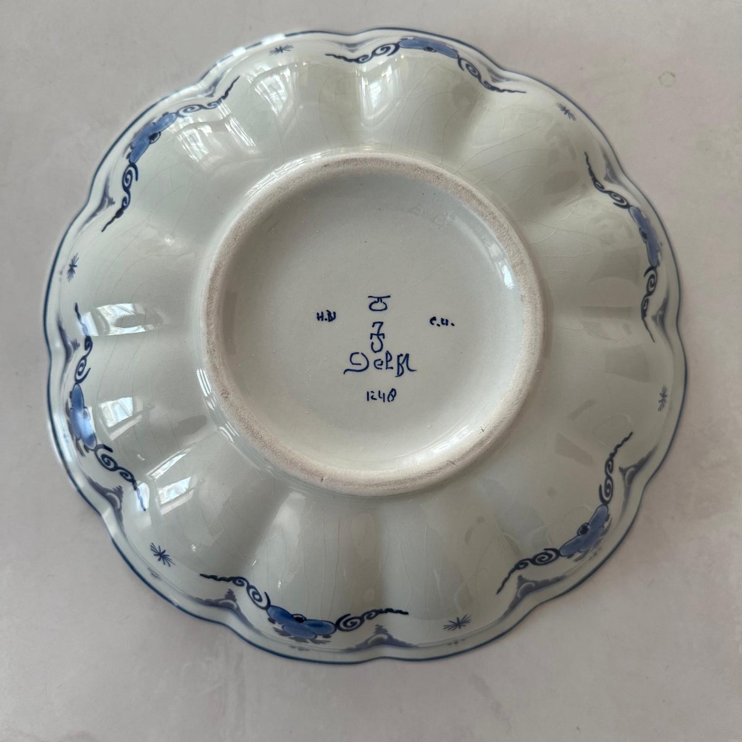 White ceramic dish with blue decorative patterns on a white background