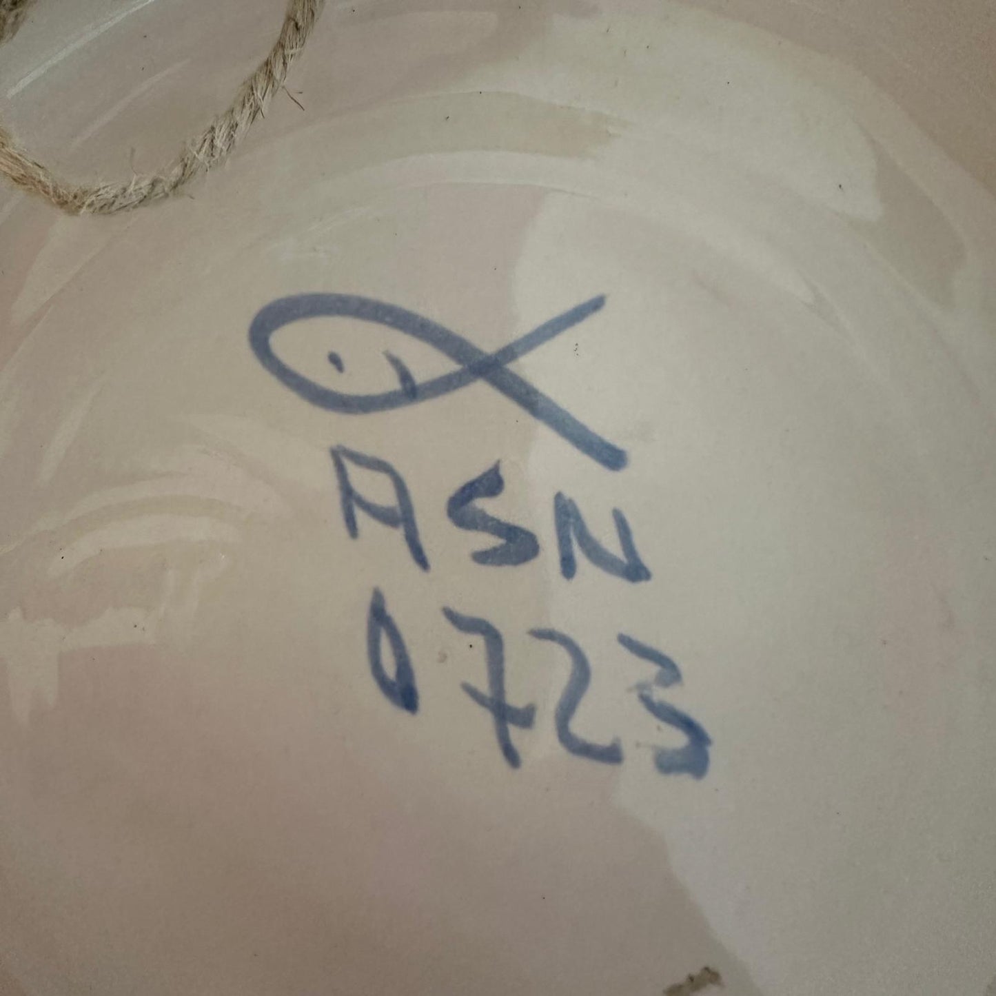 Ceramic piece with blue signature and number
