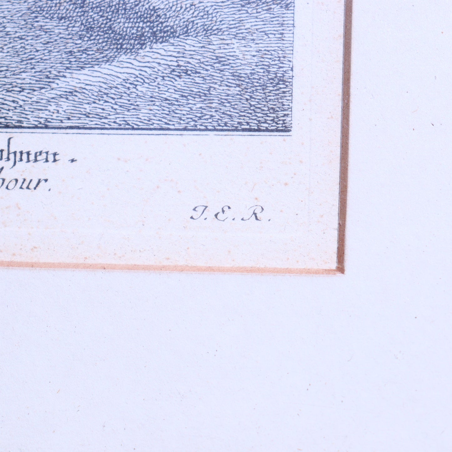 Close-up of a framed artwork with text and a signature on a light blue background