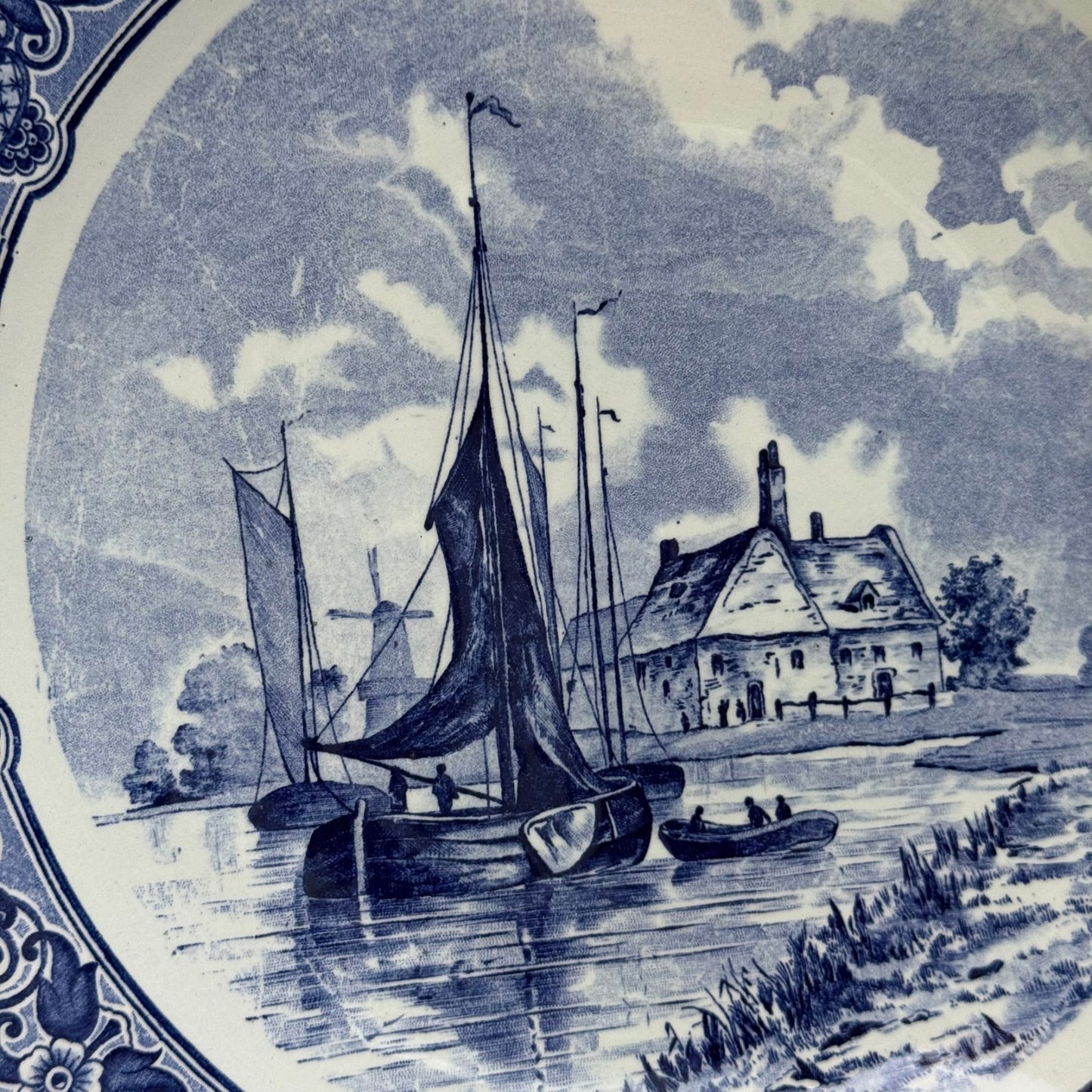 Nautical scene with boats and a house on a decorative plate