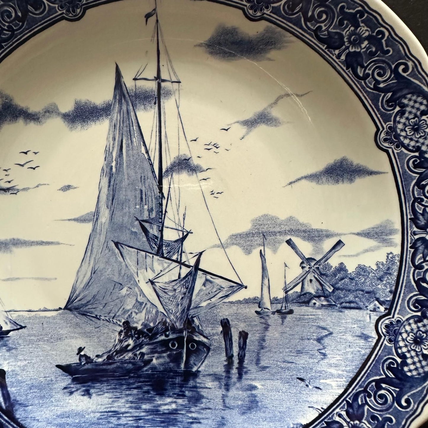 Decorative plate with blue and white ship and mill design