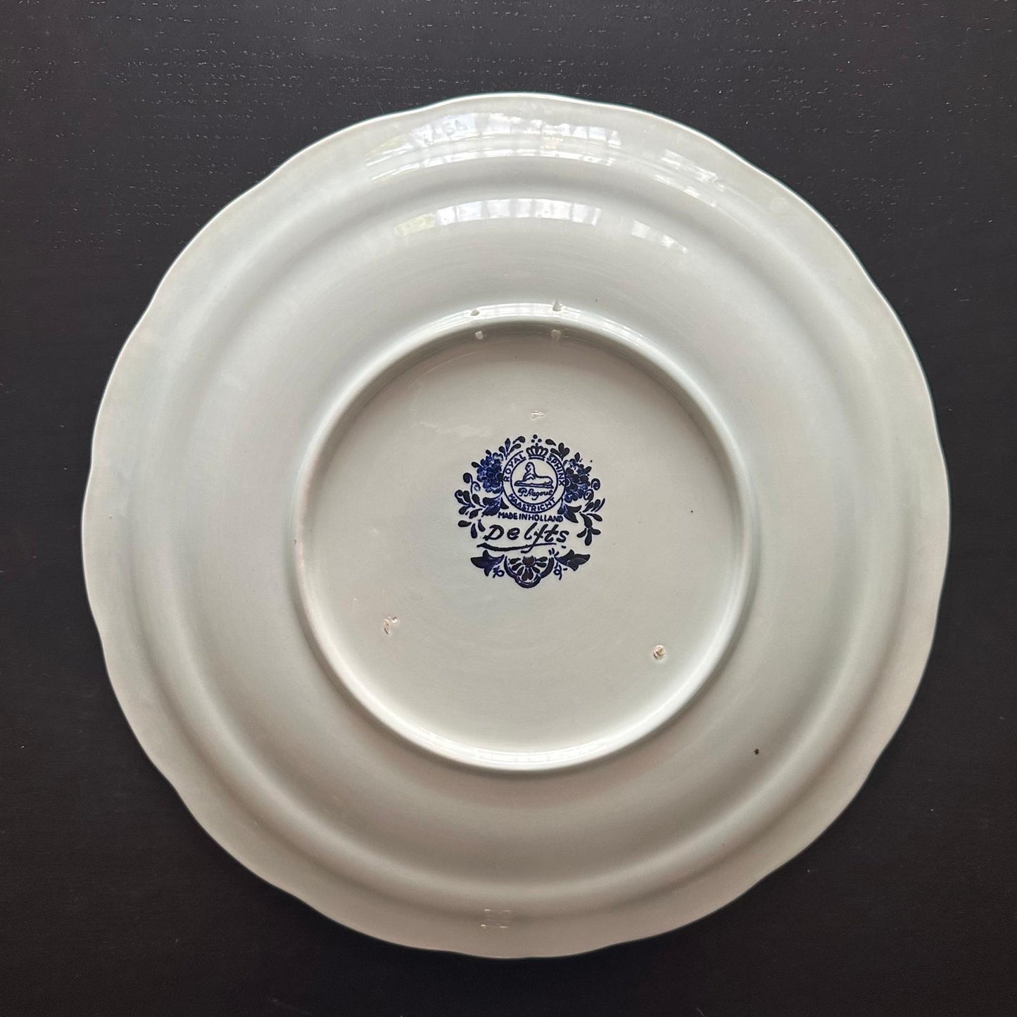 White ceramic plate with blue floral design on a black background