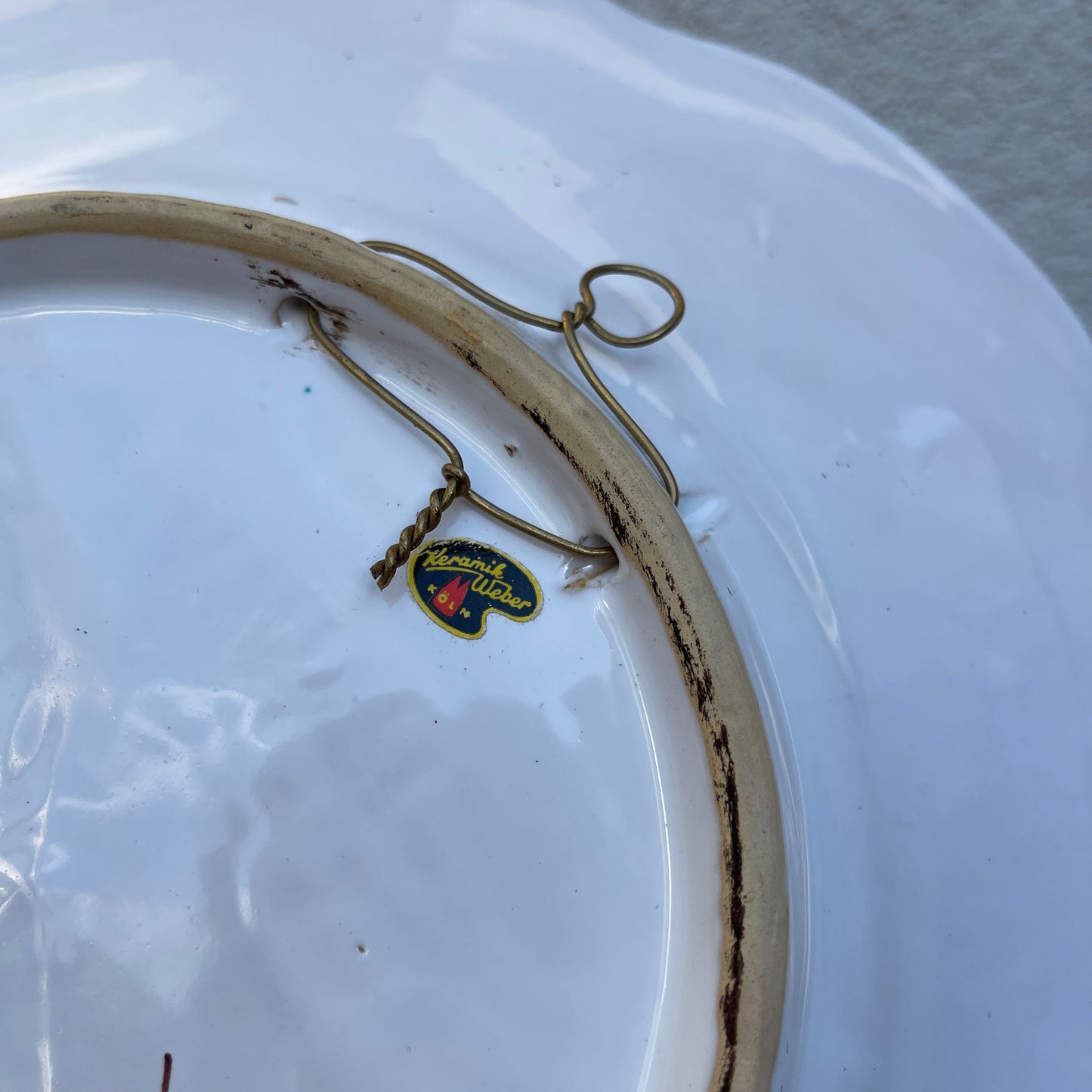 Small decorative item with a logo on a white plate