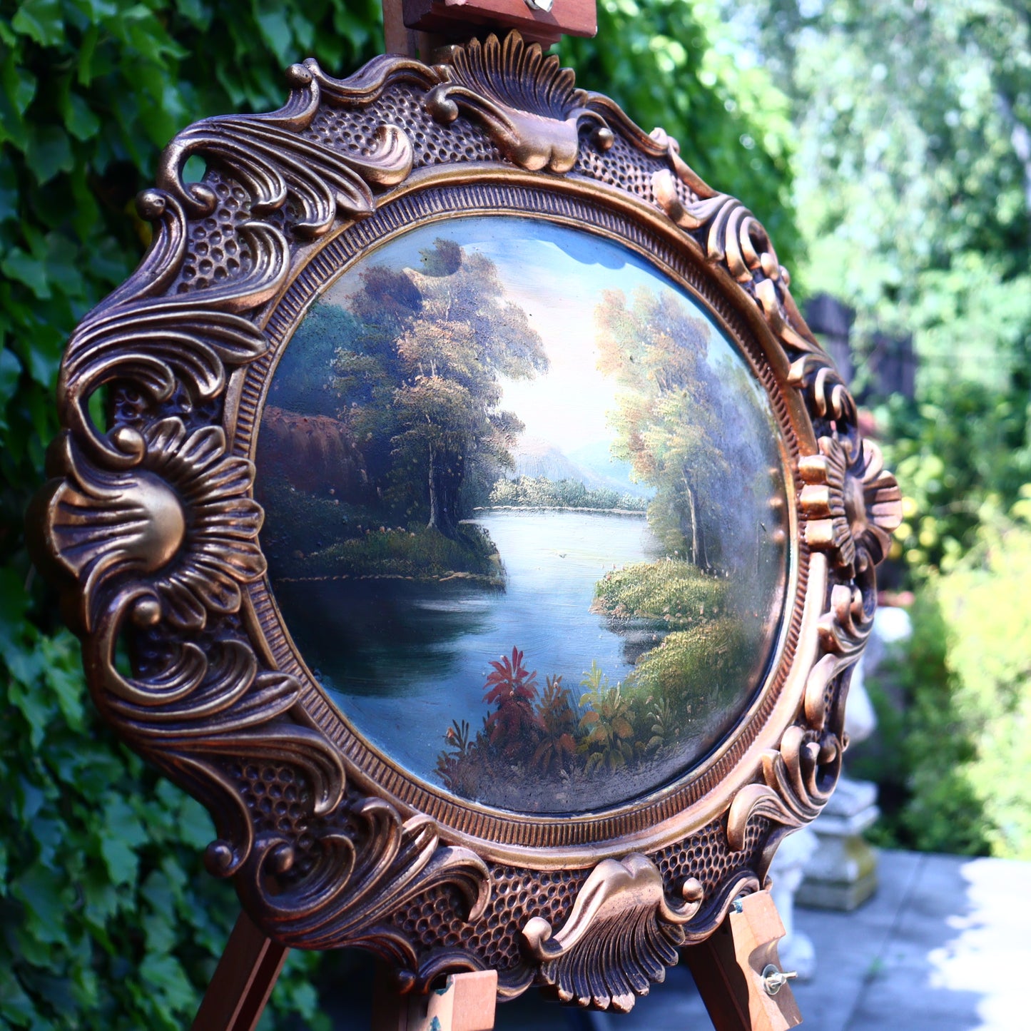 Landscape on wood in an oval frame