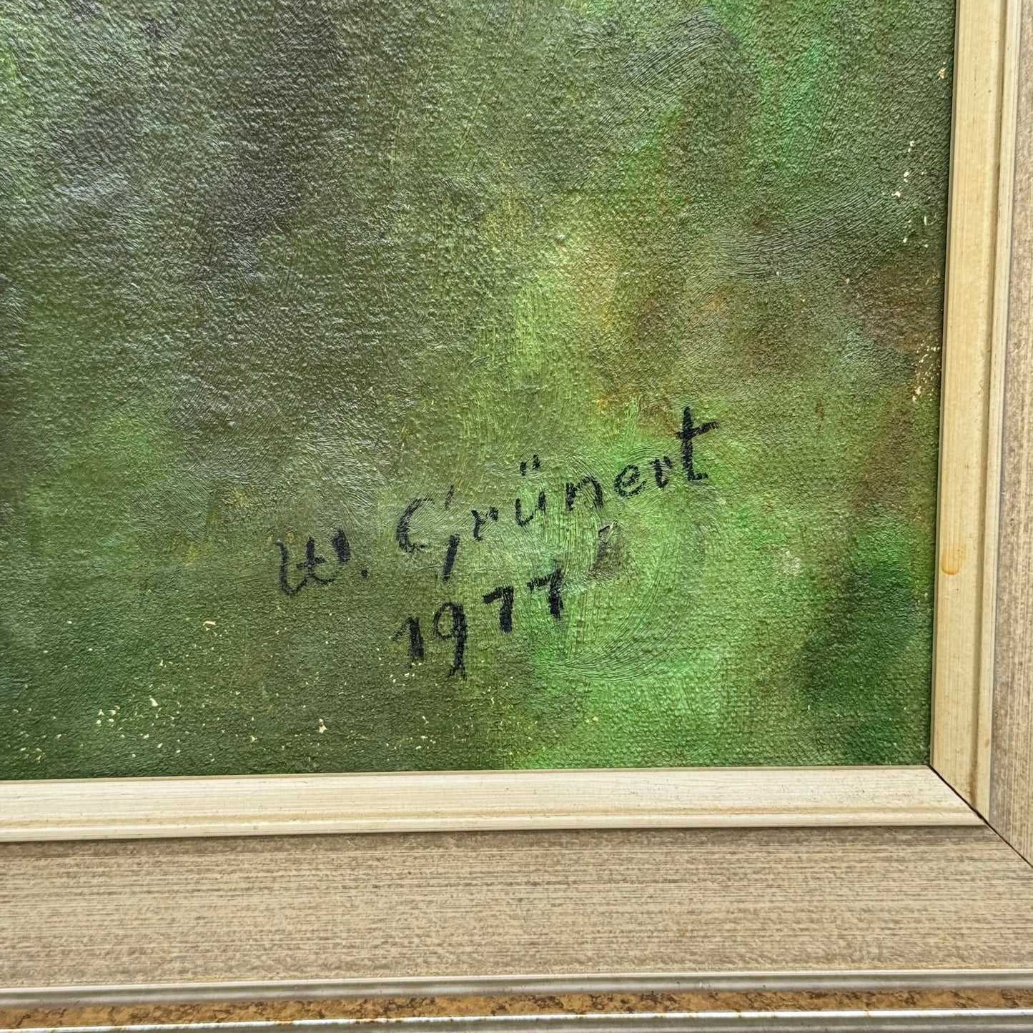 Signature and year on a textured green background