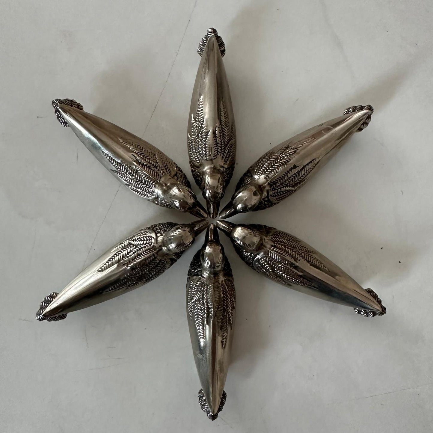Decorative silver starfish on a light gray surface