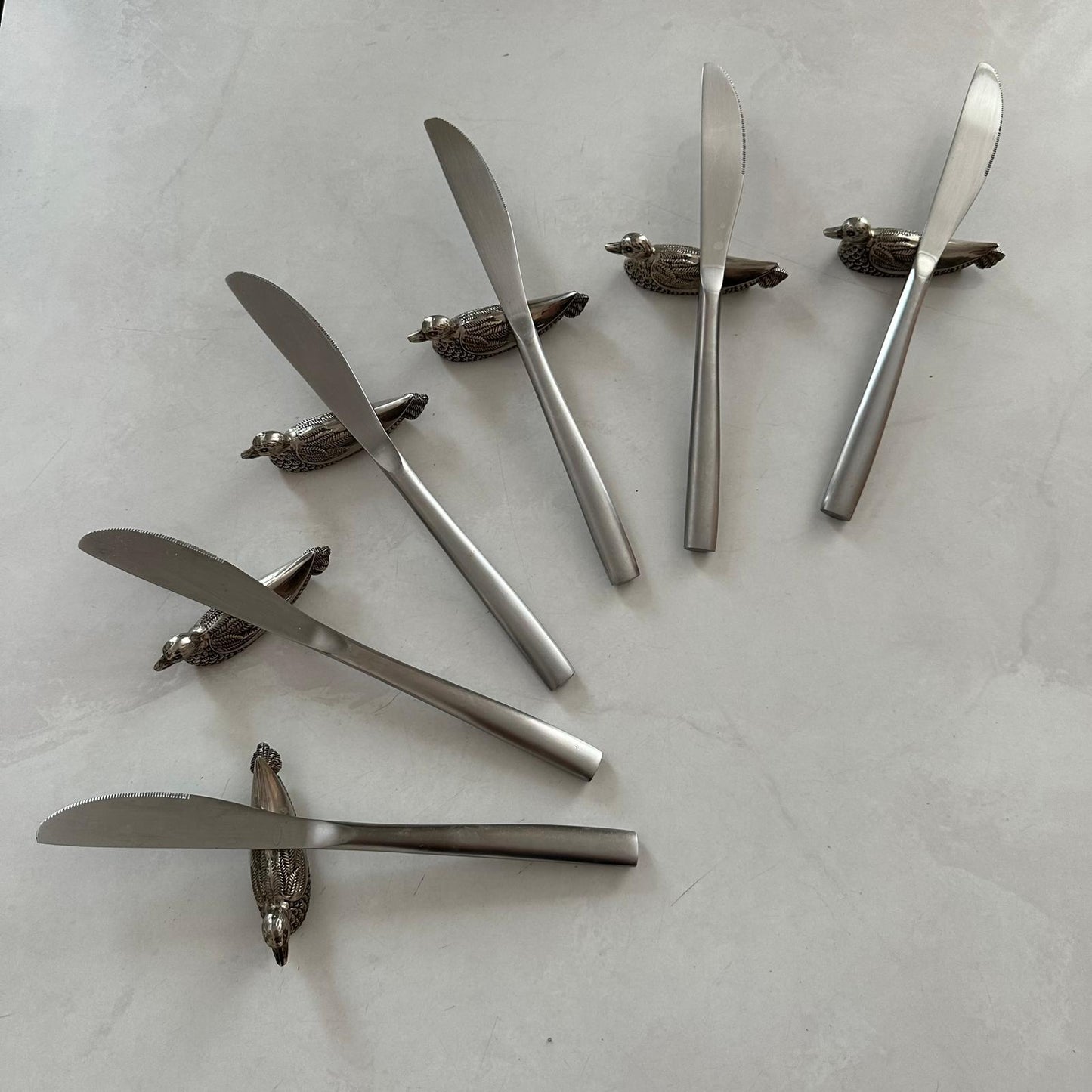 Set of six knife rests with knives