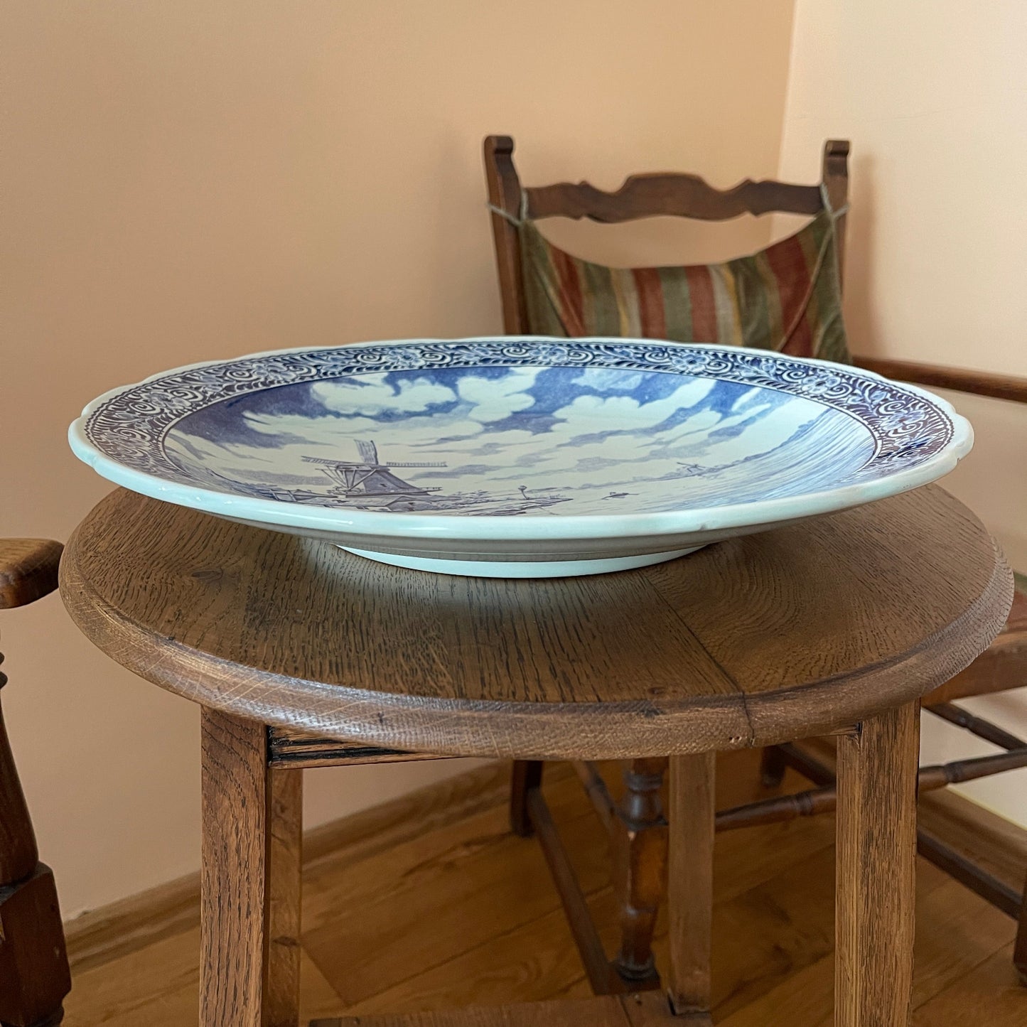 Decorative plate with blue and white design on a wooden table