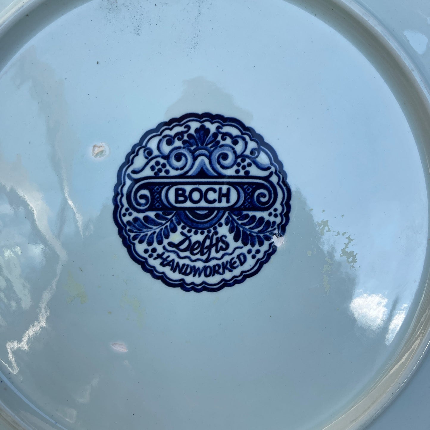 Boch logo on a ceramic plate with blue design