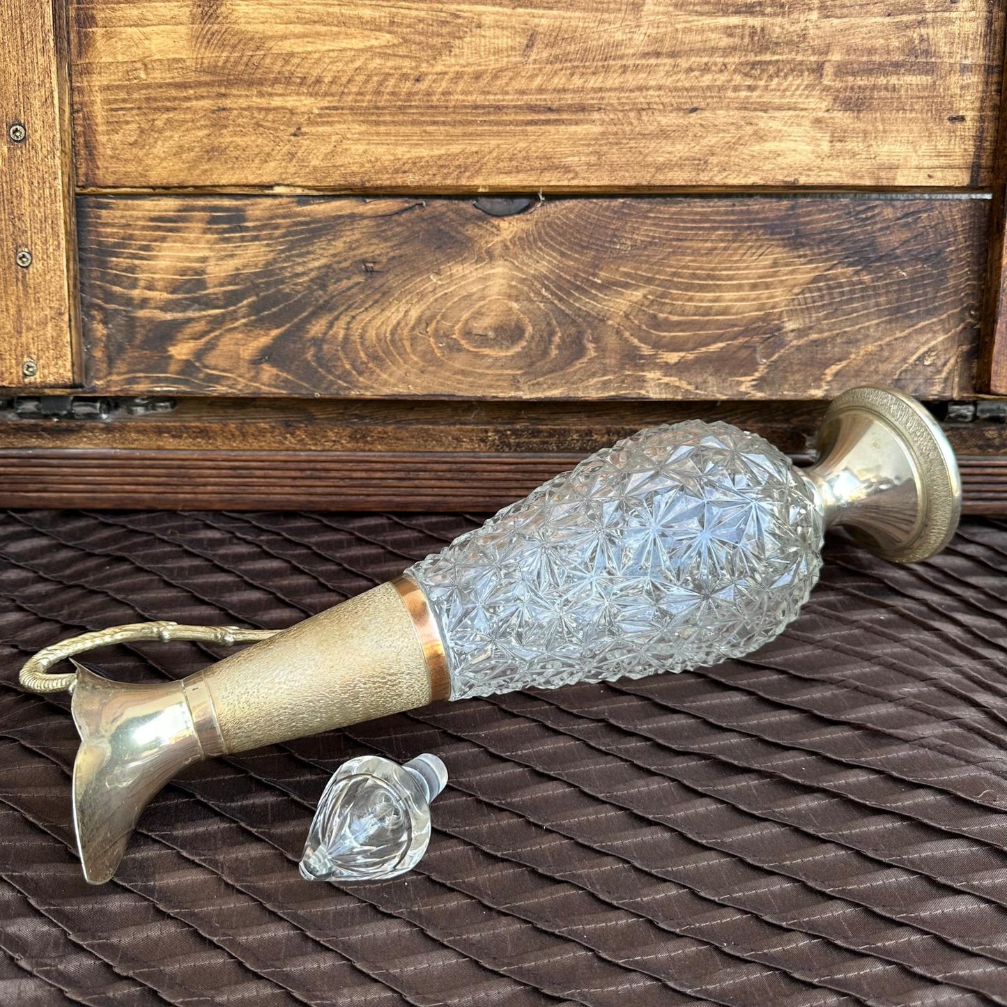 Decorative glass and brass object on a wooden surface