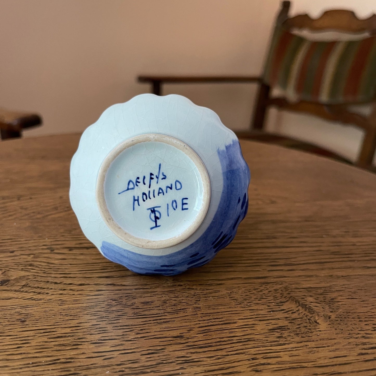 Ceramic vase with 'Delft's Holland' inscription on a wooden surface
