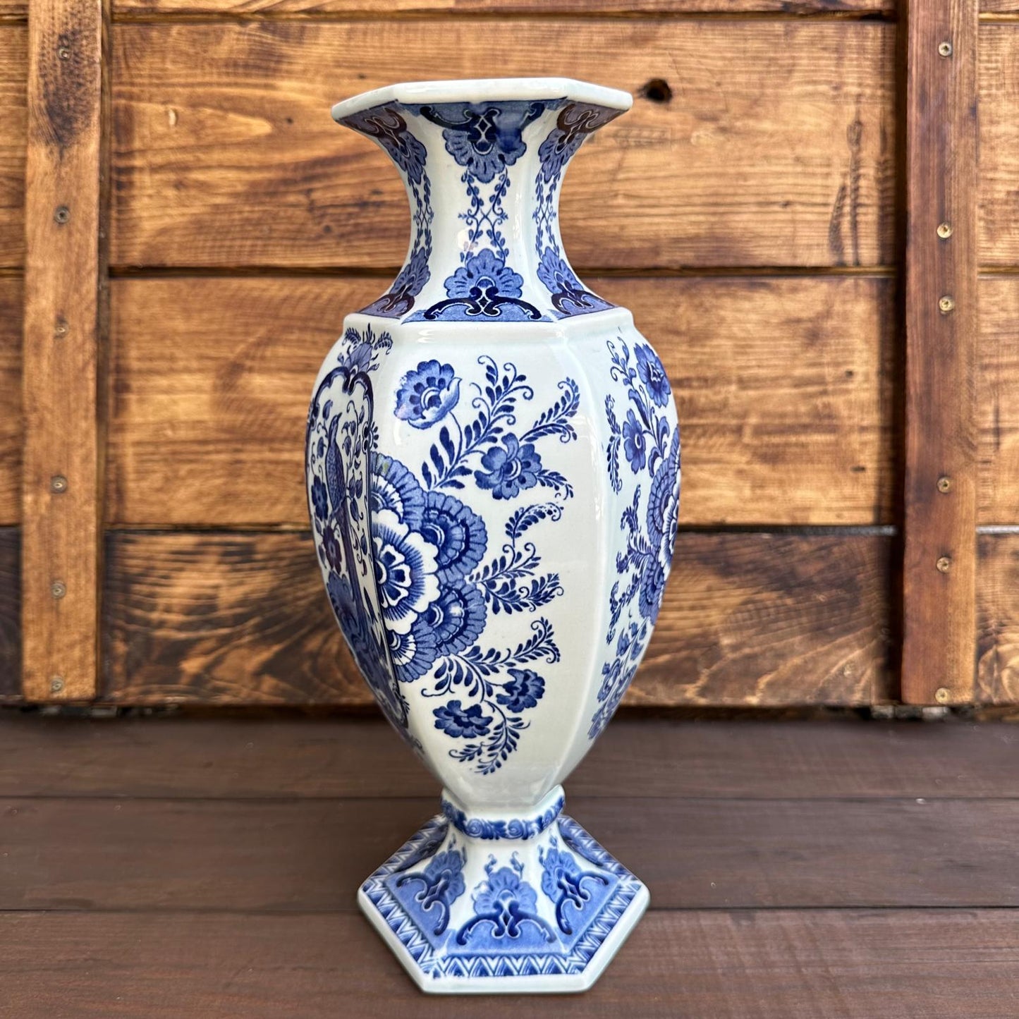 Blue and white floral-patterned vase against a wooden background