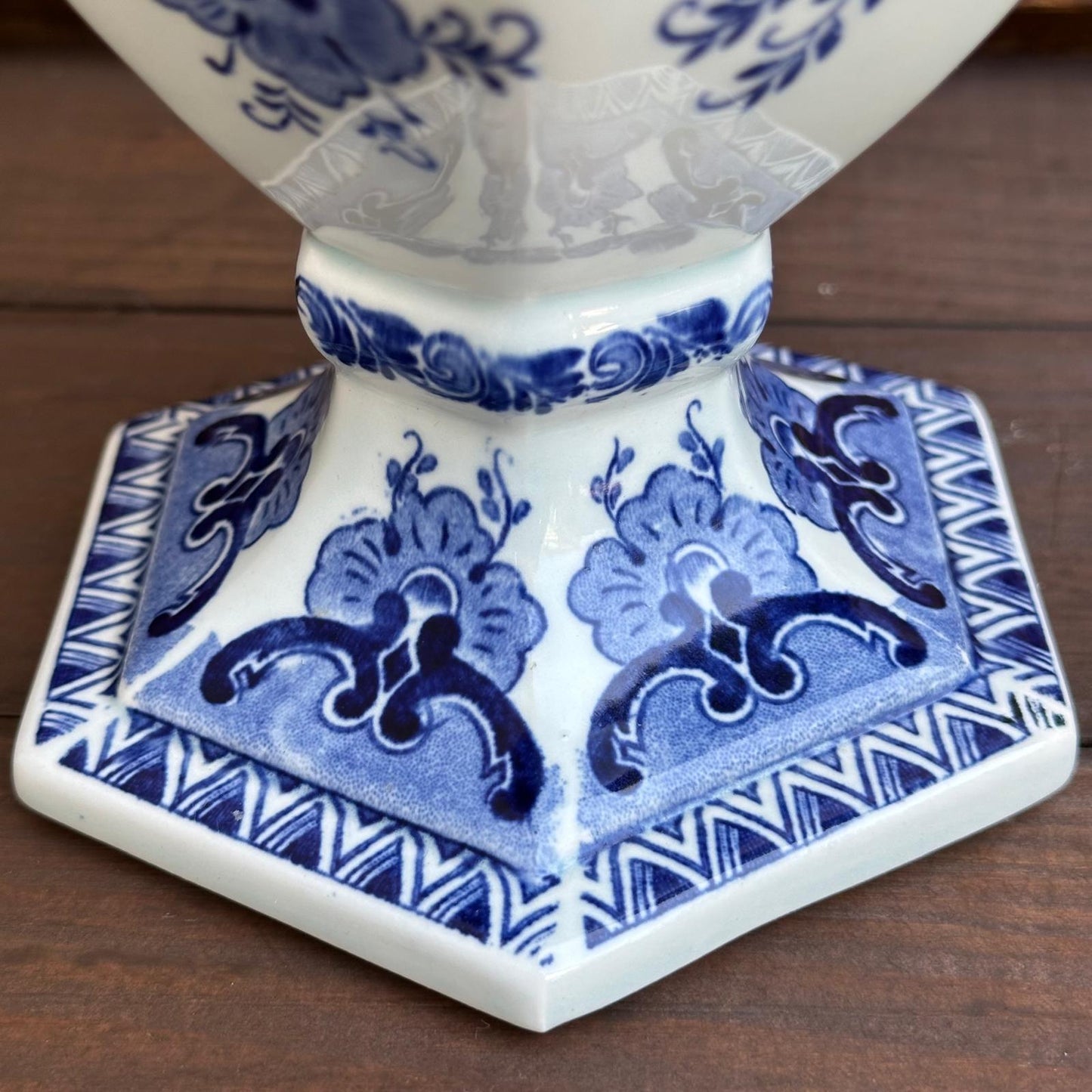 Ceramic vase with blue and white floral patterns on a wooden surface