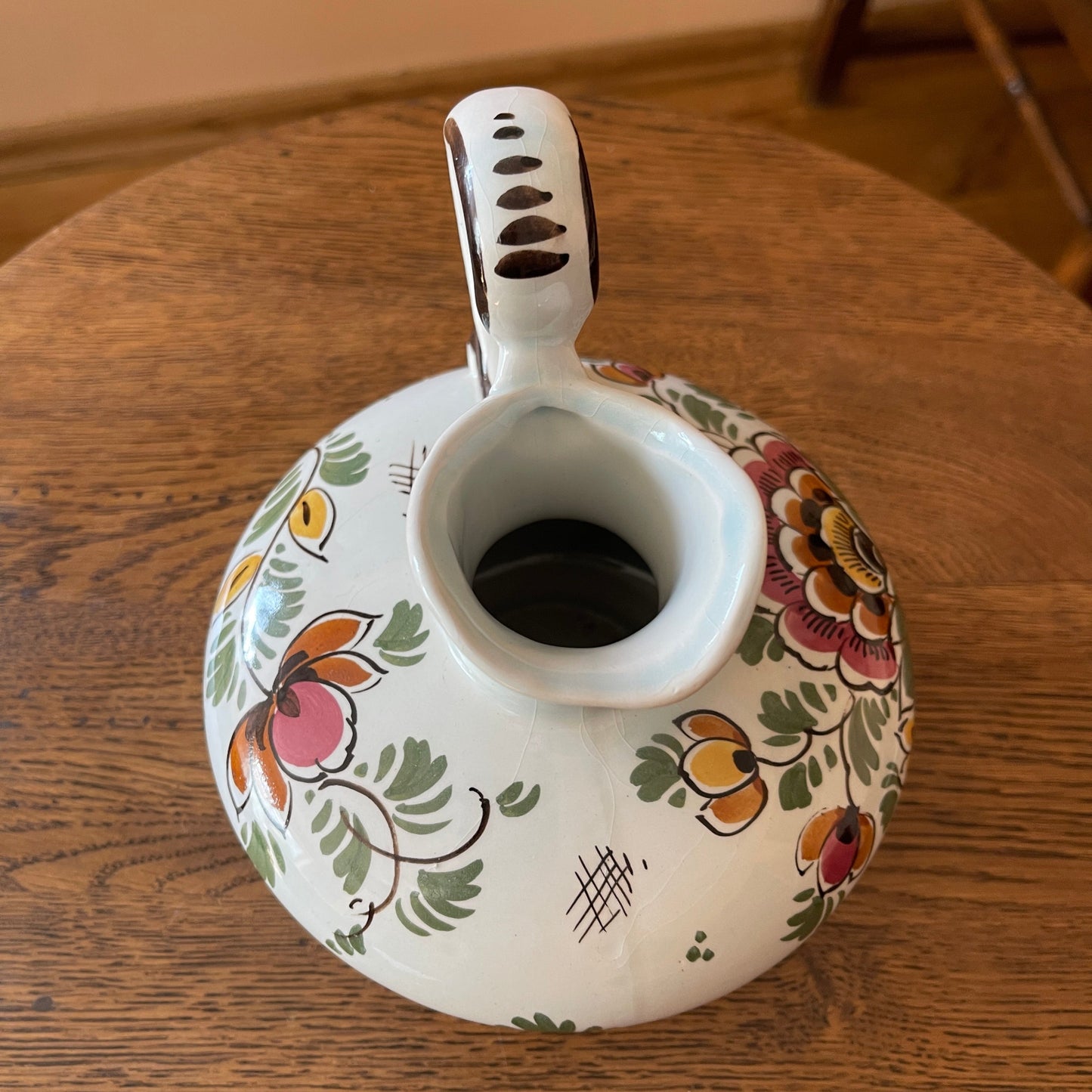 Decorative ceramic teapot with floral patterns on a wooden surface