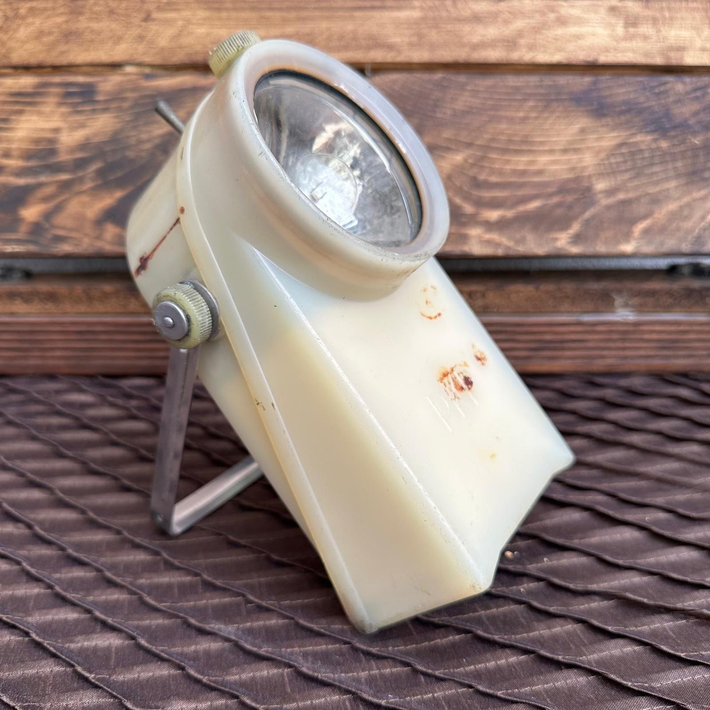 Vintage-style spotlight on a wooden surface