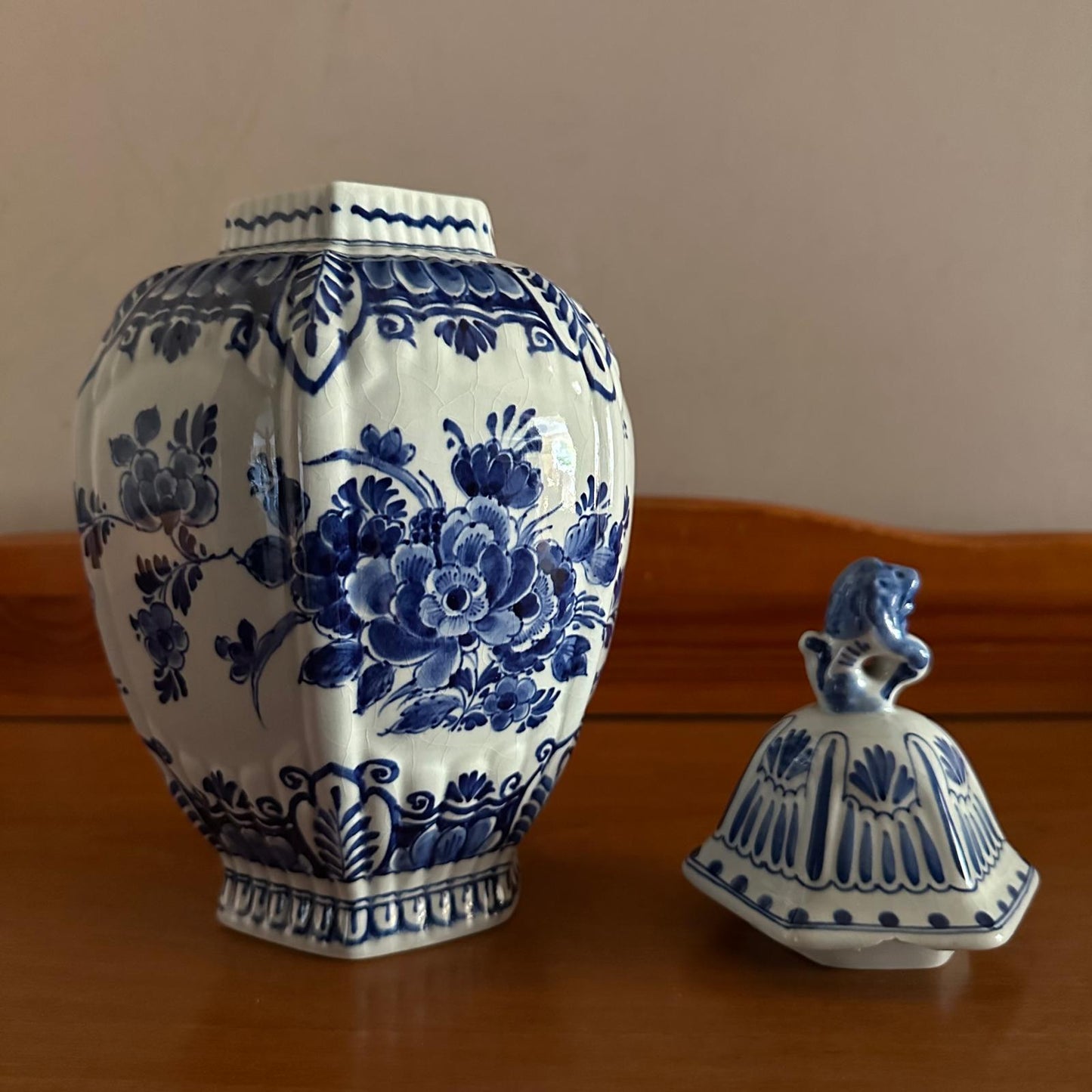 Ceramic jar with blue floral patterns on a wooden surface