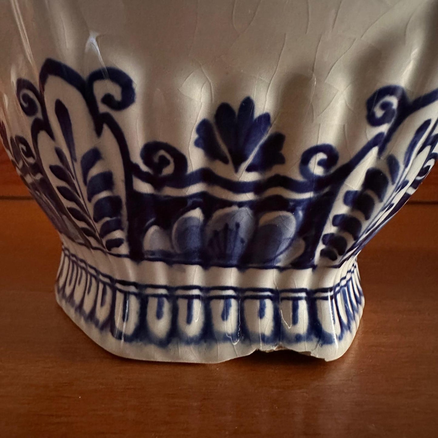 Close-up of a ceramic vase with blue floral patterns on a wooden surface