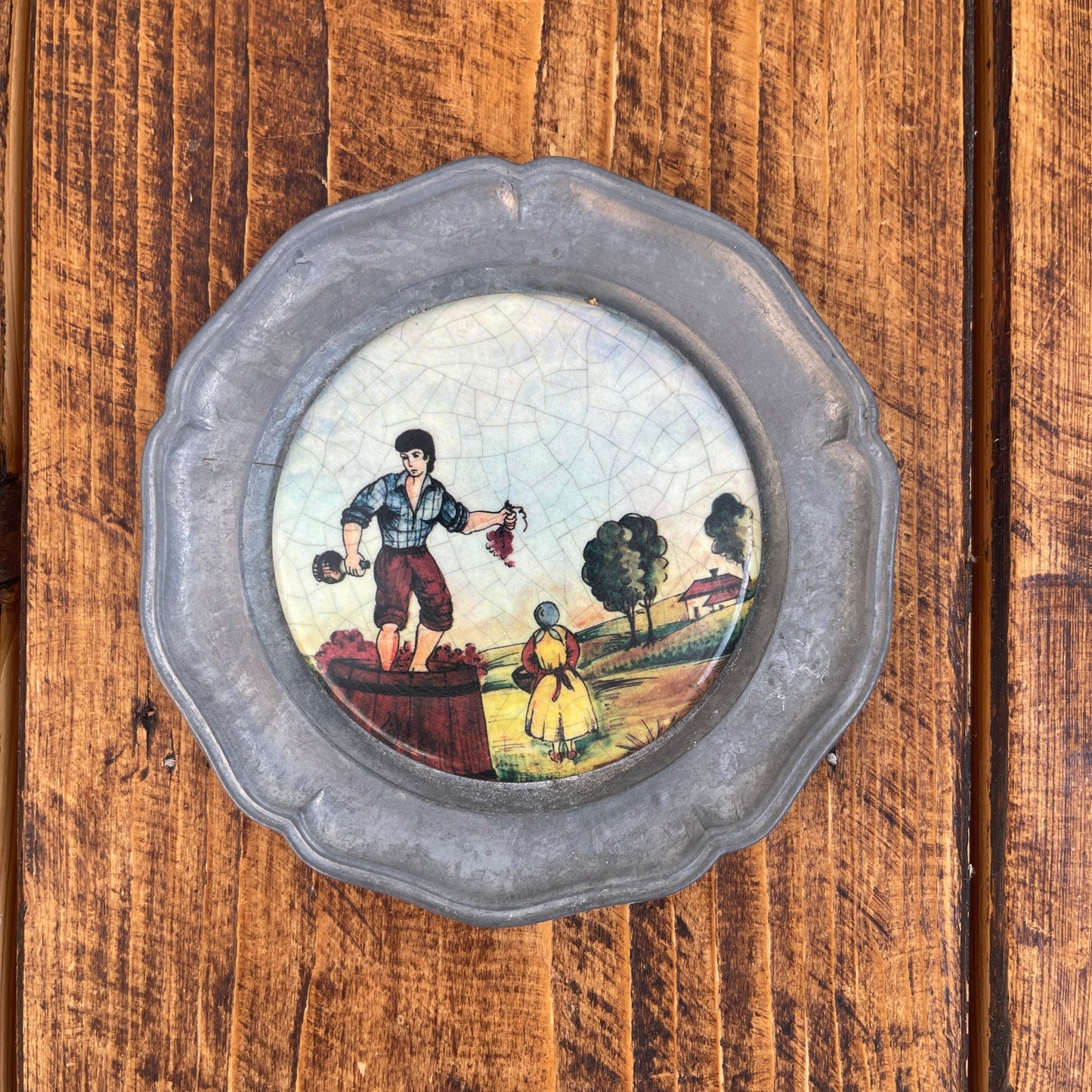 Decorative plate with a scenic design on a wooden surface