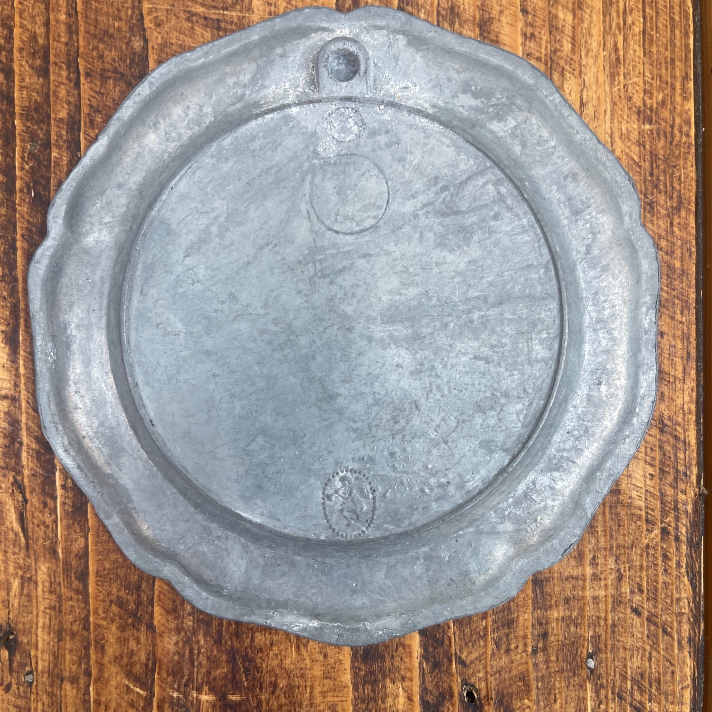 Metallic circular object on a wooden surface