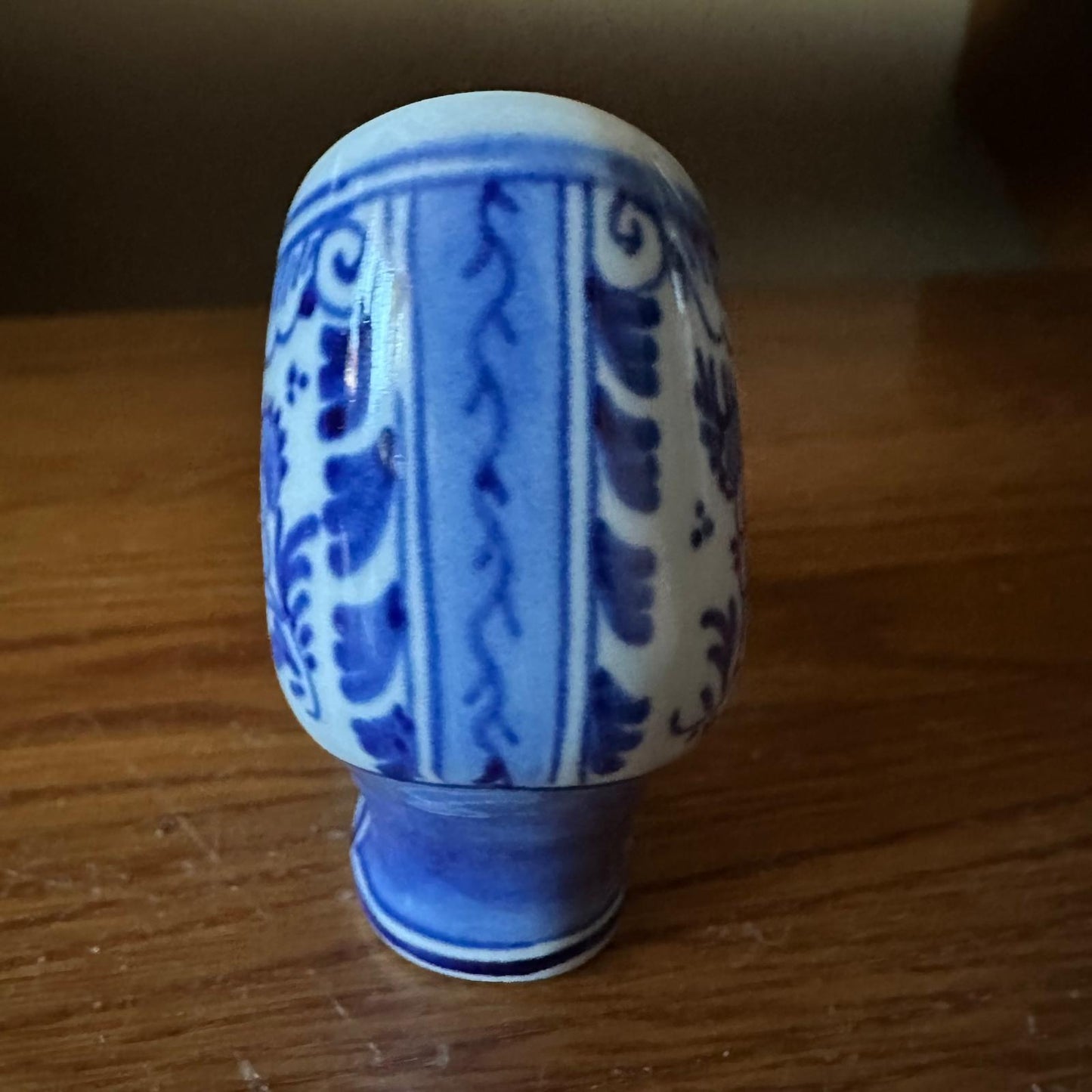 Blue and white ceramic vase on a wooden surface