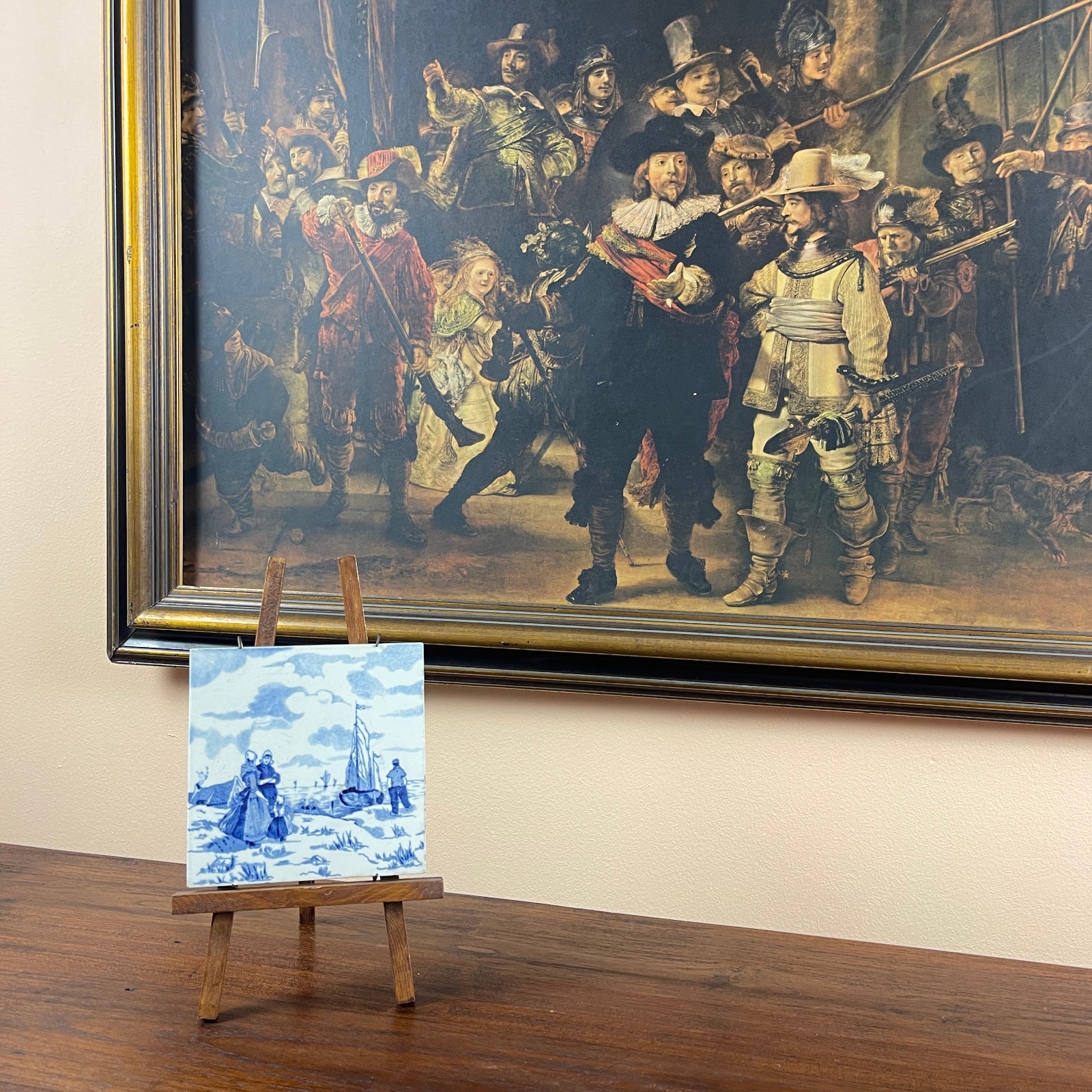 Framed painting of a historical scene with a smaller replica on an easel below.