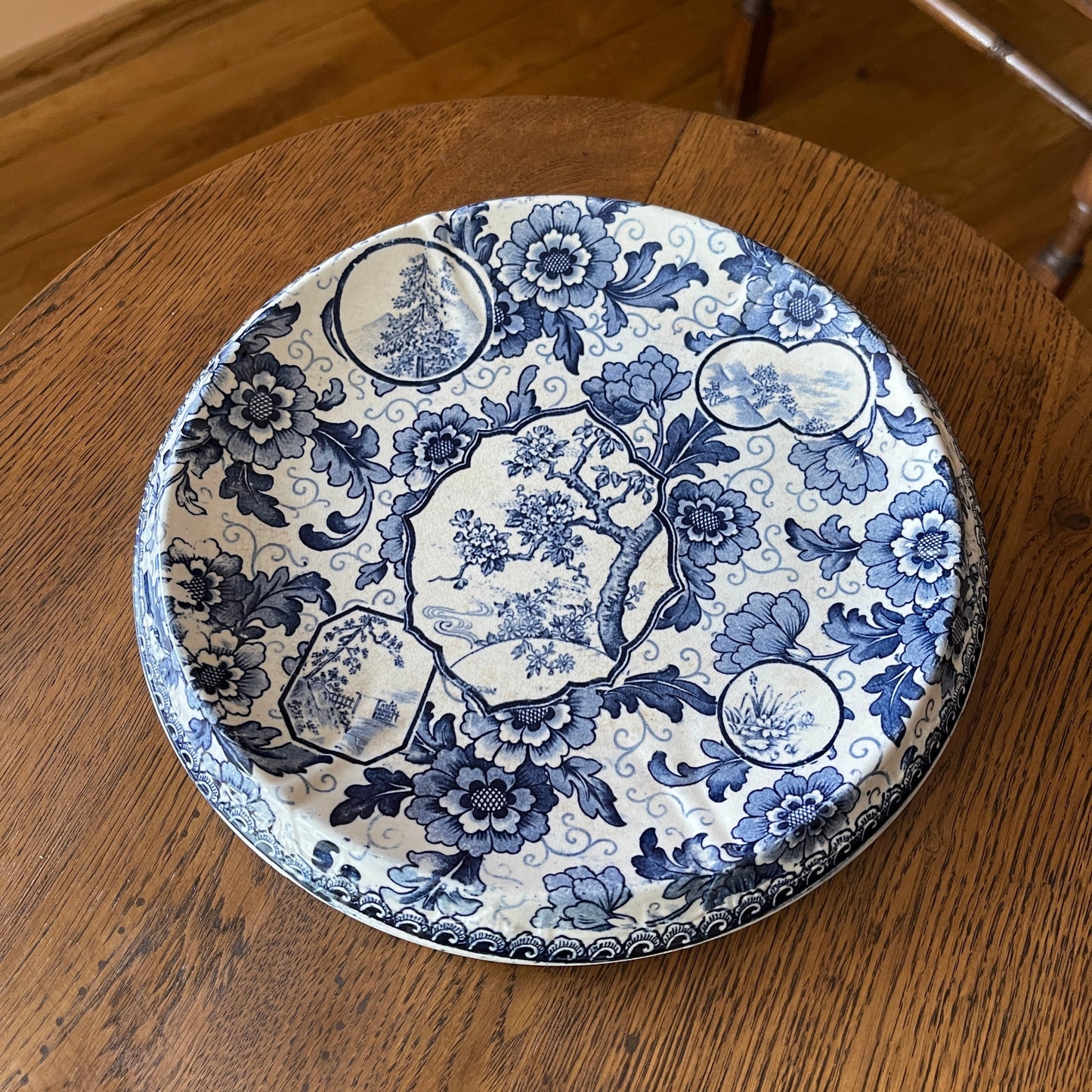 Decorative blue and white plate on a wooden surface