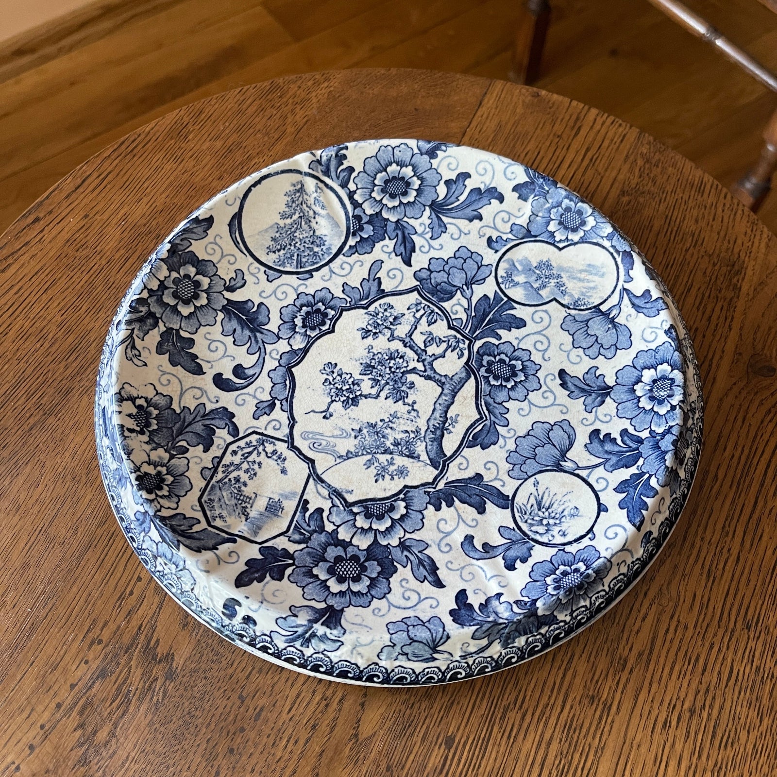 Decorative blue and white plate on a wooden surface