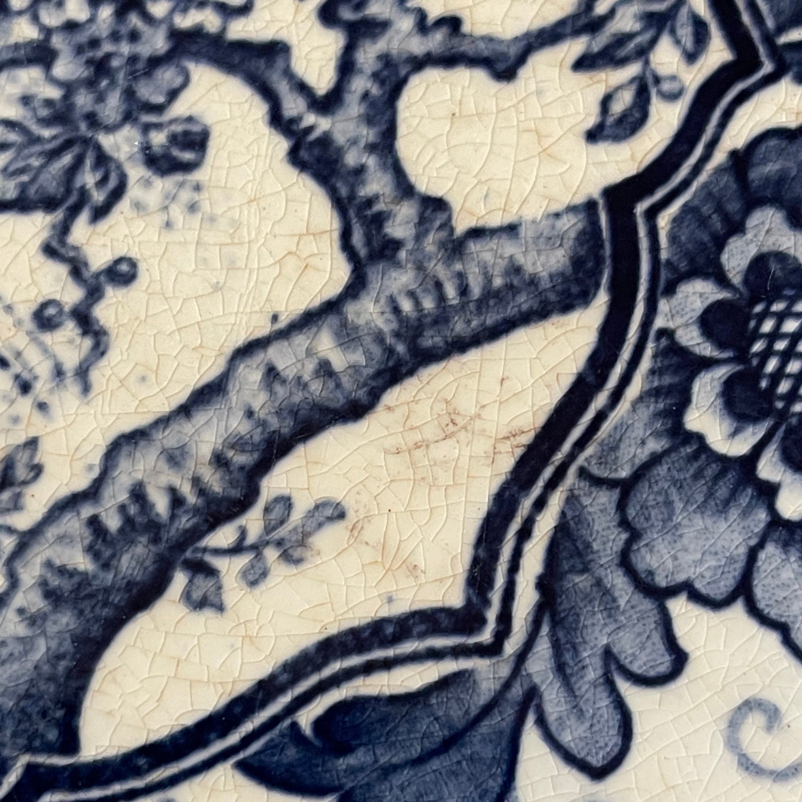 Close-up of blue floral pattern on ceramic tile