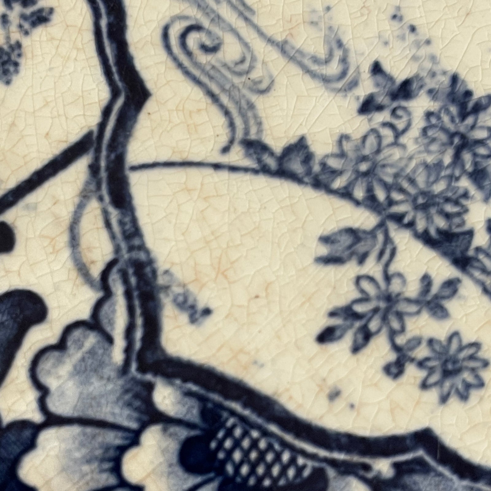 Close-up of blue floral pattern on ceramic tile