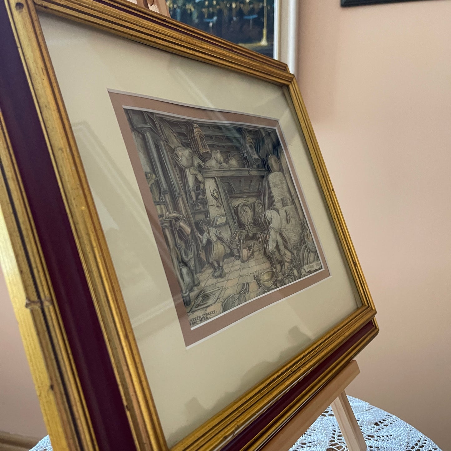 Framed artwork on a stand with a neutral background