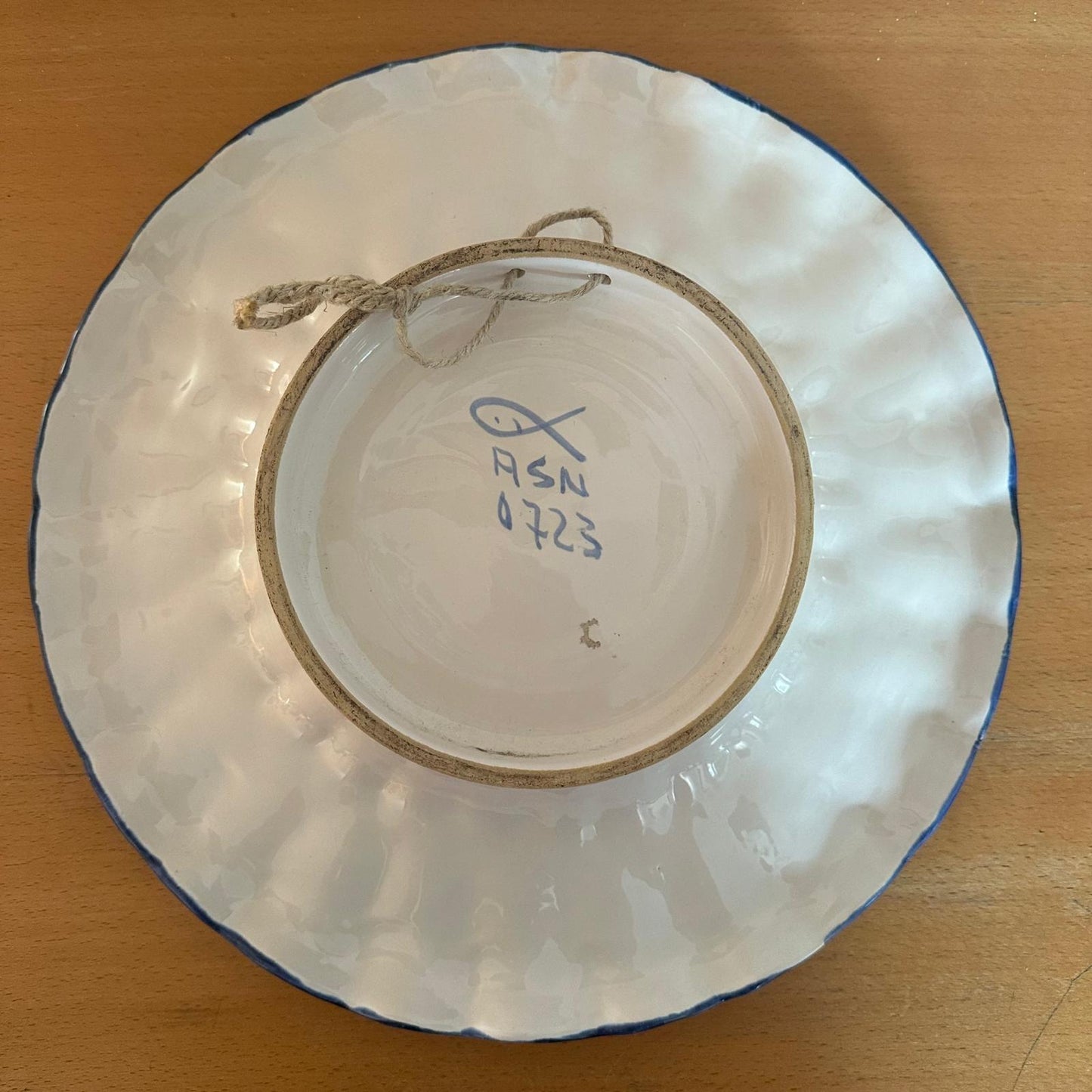 The back of the ceramic plate with the manufacturer's mark