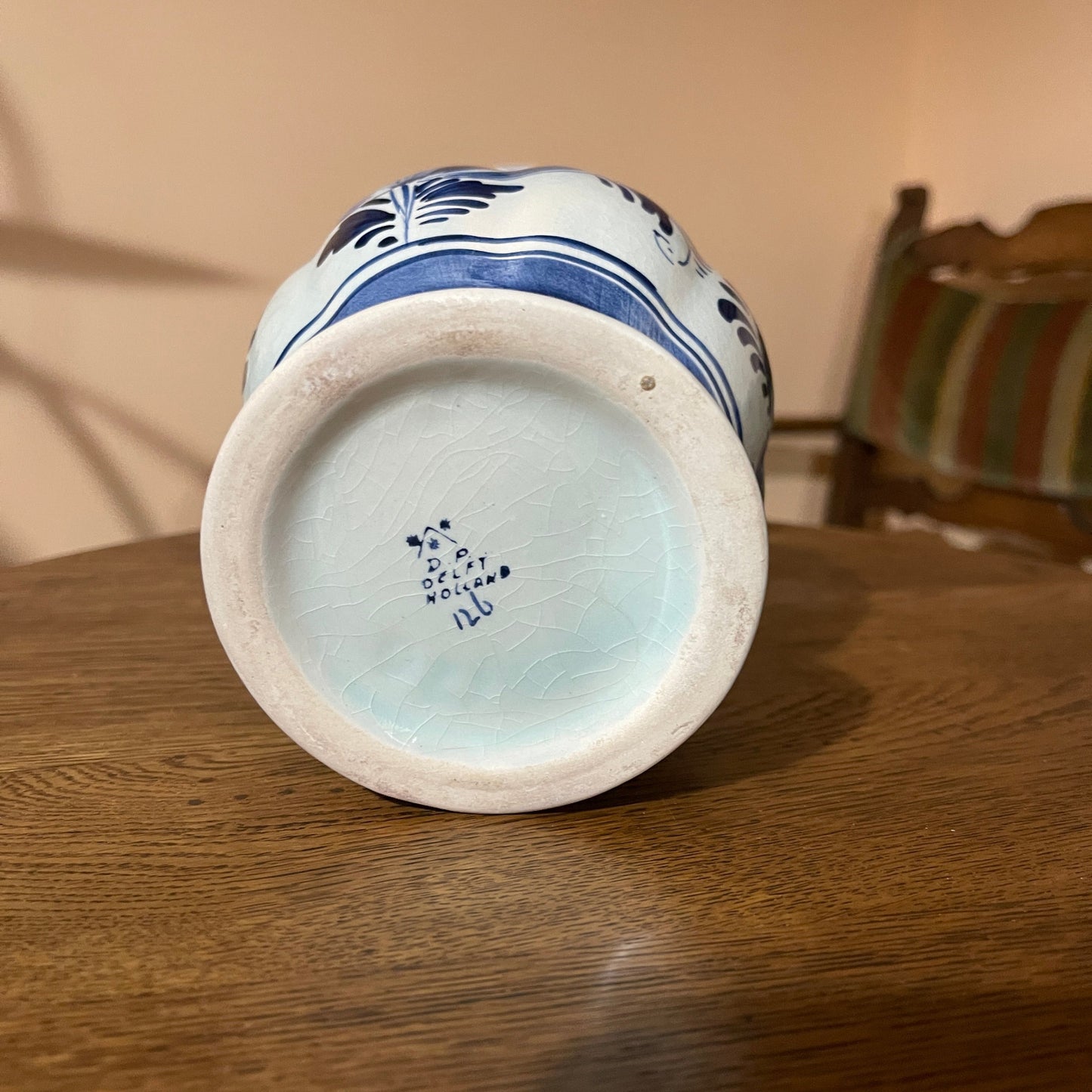 Ceramic vase with blue and white design on a wooden surface