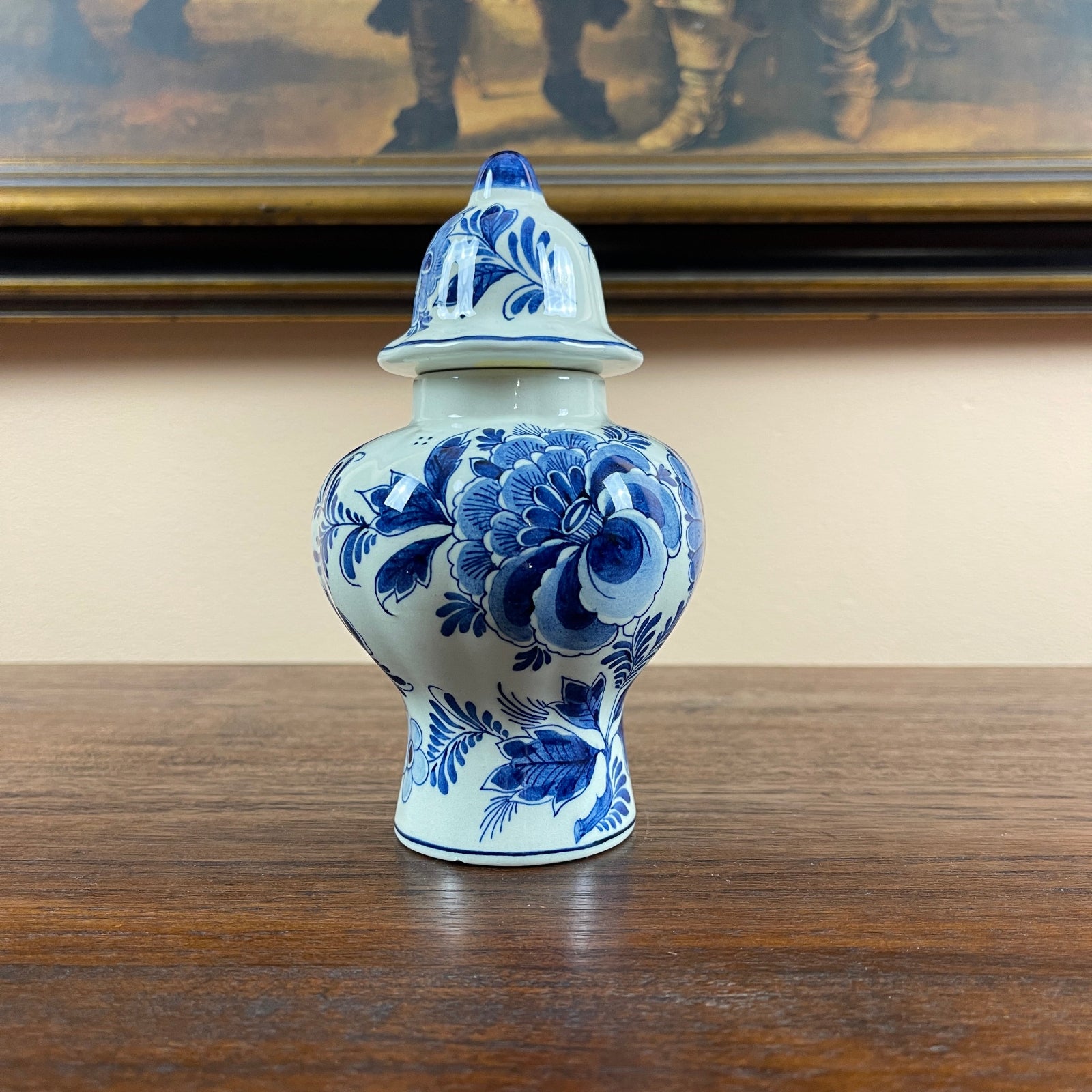 Blue and white ceramic vase with floral patterns on a wooden surface