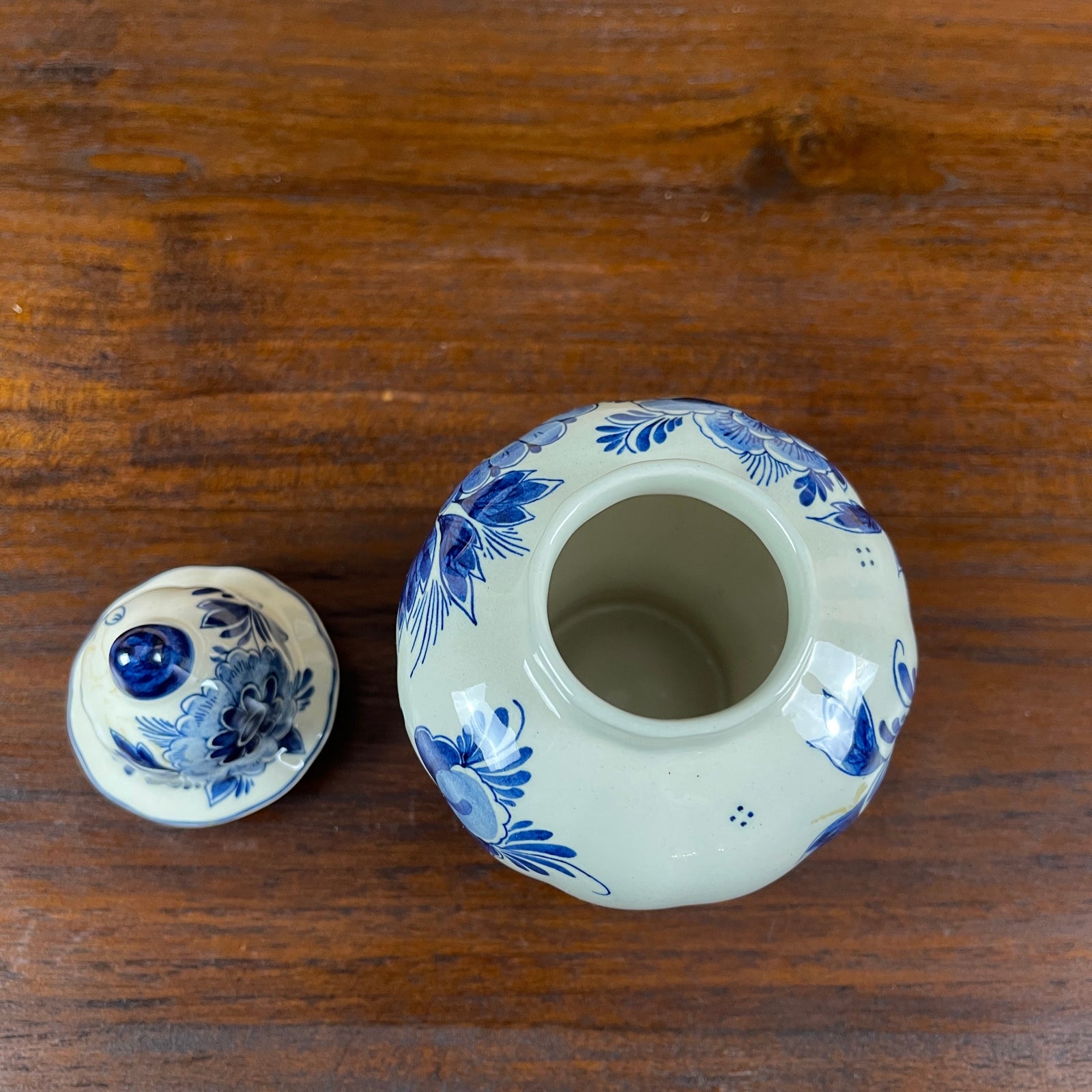 Ceramic container with blue floral patterns on a wooden surface