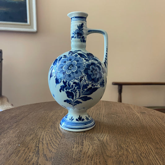 Blue and white floral-patterned ceramic vase on a wooden table