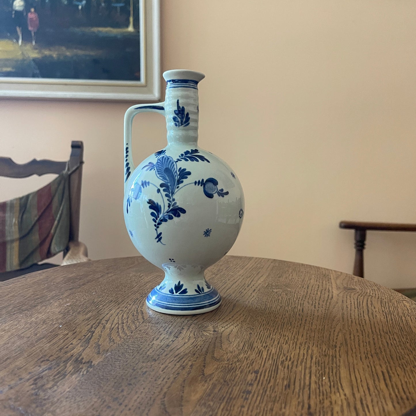 Blue and white floral-patterned vase on a wooden table with a blurred background