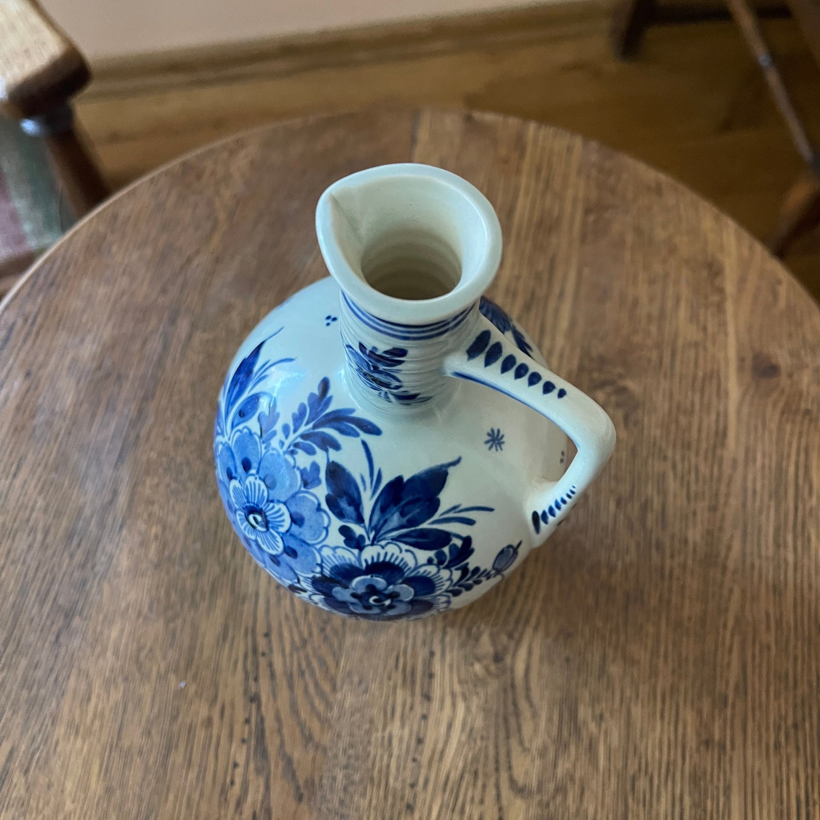 Blue and white floral-patterned vase on a wooden table