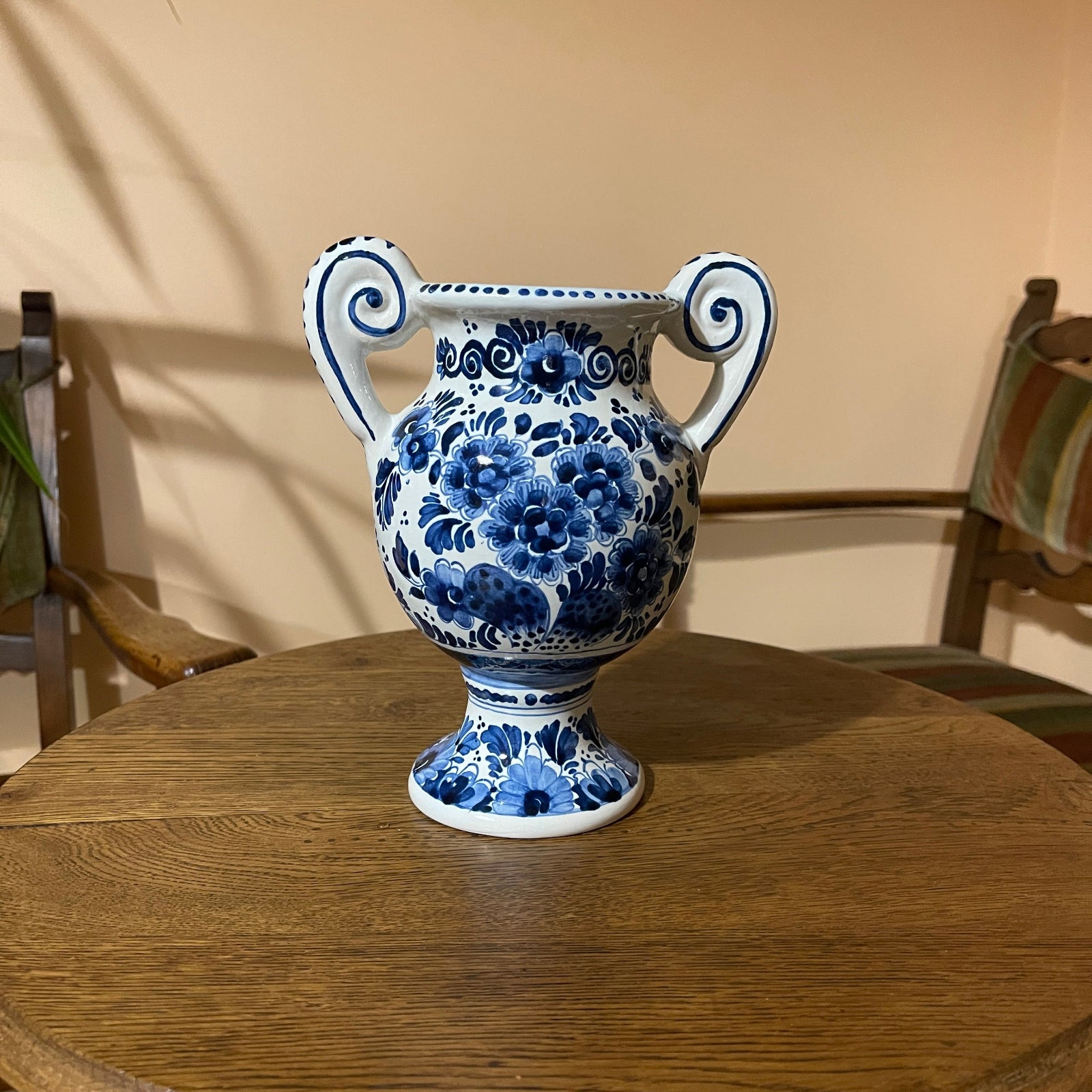 Blue and white floral-patterned vase on a wooden table