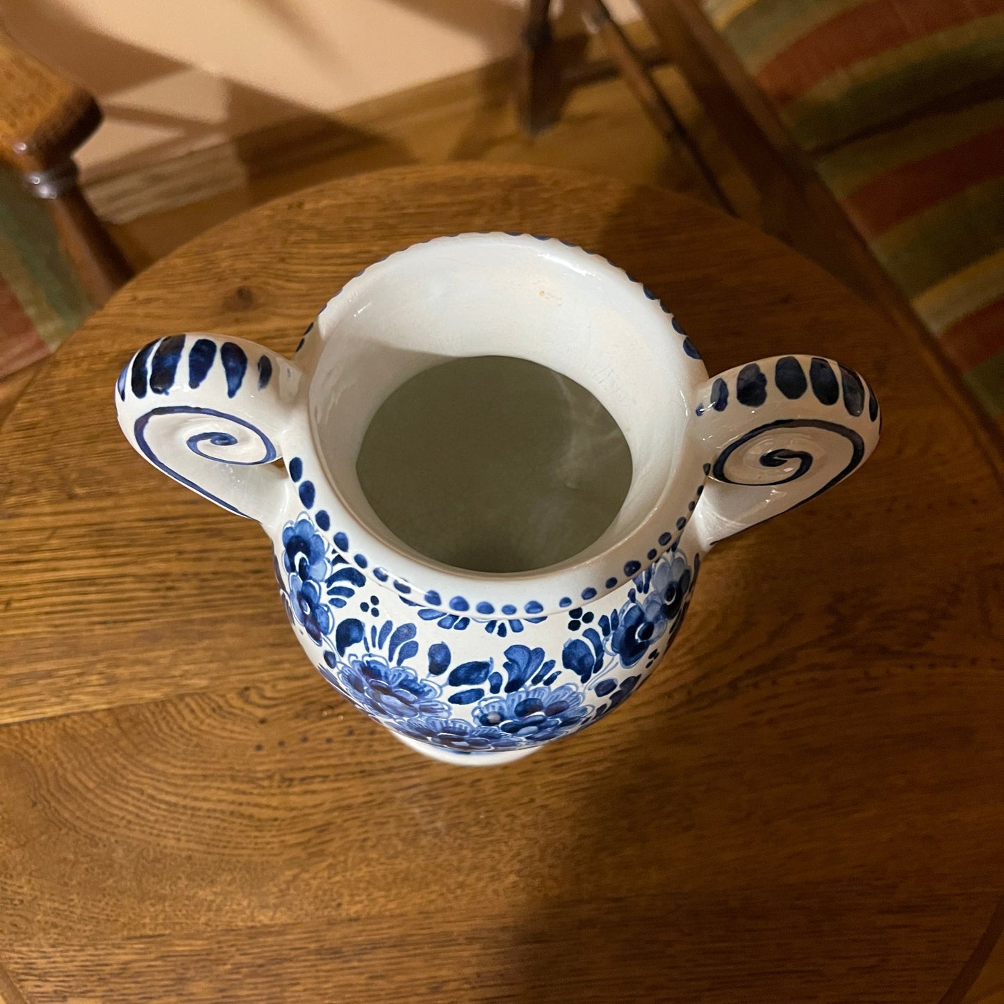Ceramic pitcher with blue floral patterns on a wooden table