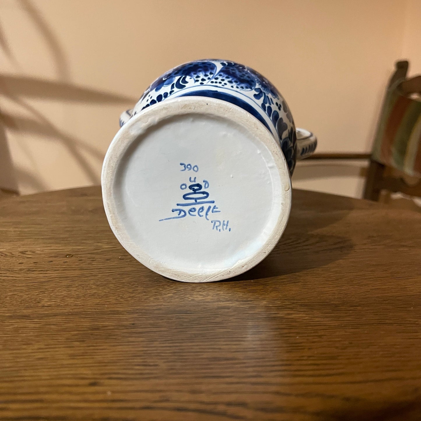 Ceramic mug with blue and white design on a wooden surface