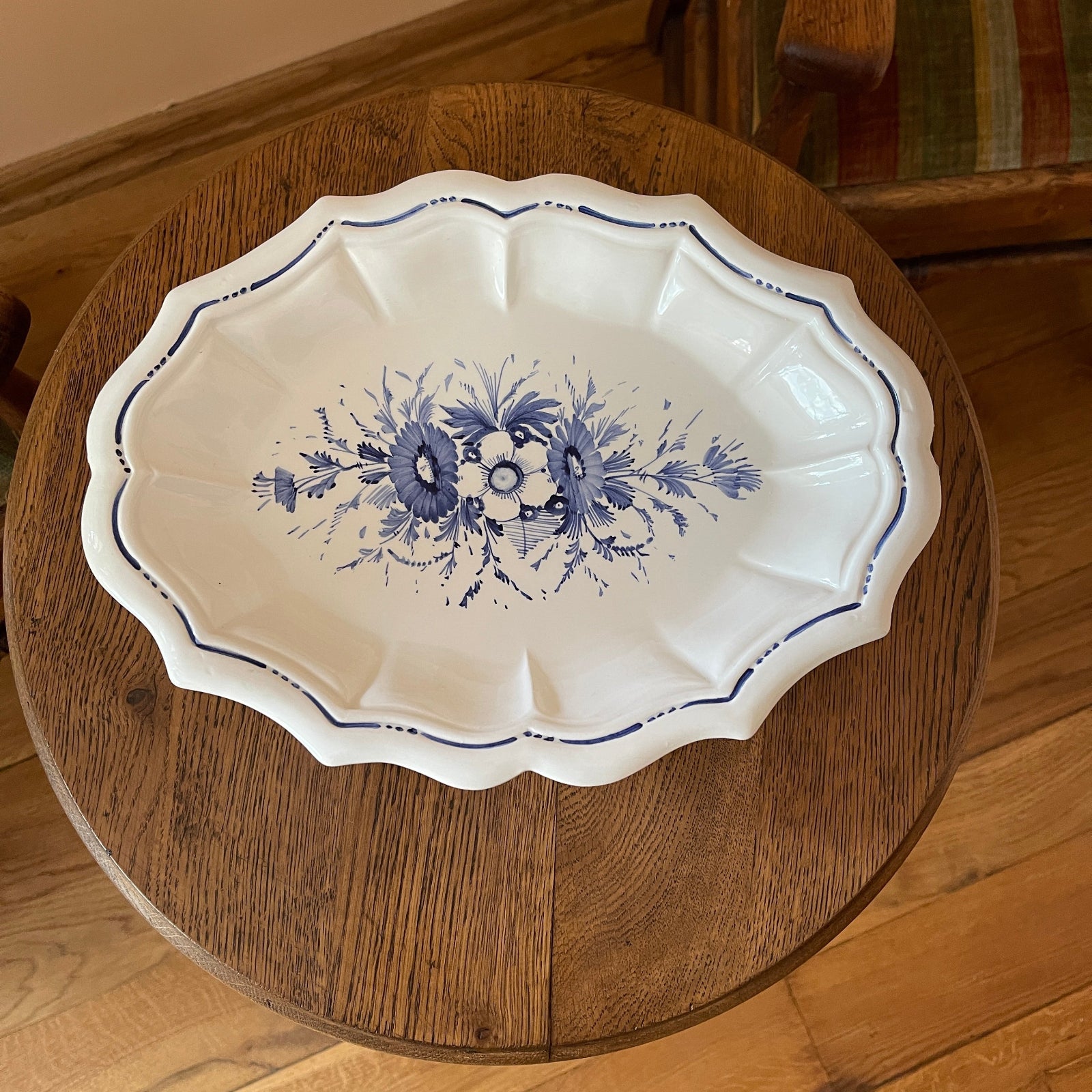White dish with blue floral patterns on a wooden surface