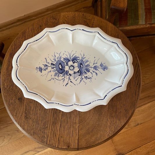 White dish with blue floral patterns on a wooden surface