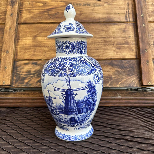 Blue and white ceramic vase with lid on a wooden surface