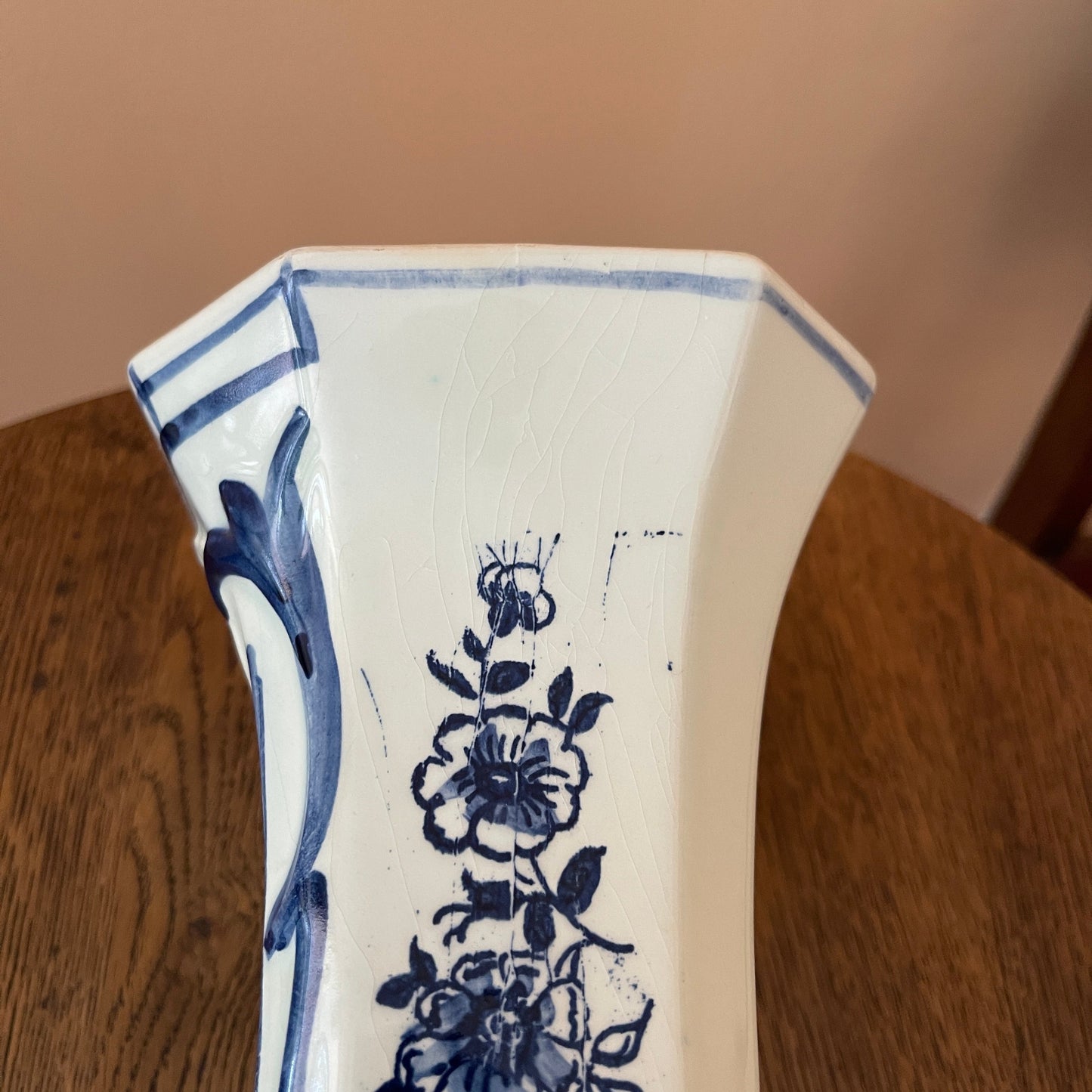 Ceramic vase with blue floral patterns on a wooden surface