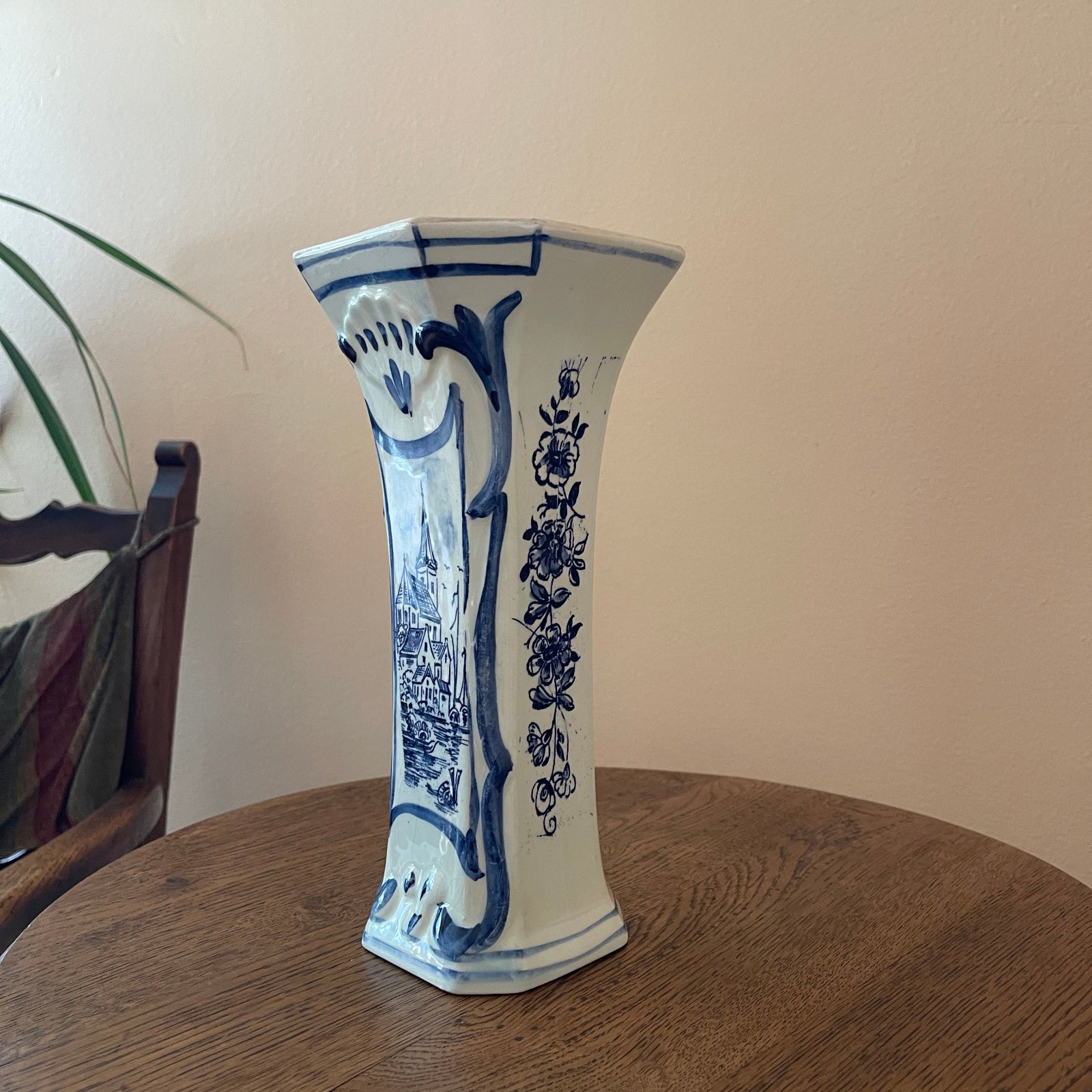 Blue and white ceramic vase on a wooden table with a neutral background