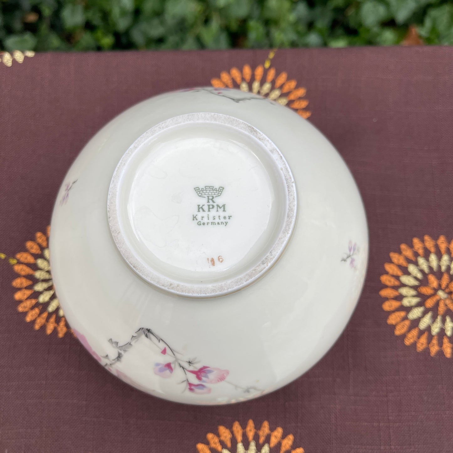 Ceramic bowl with floral patterns on a decorative surface