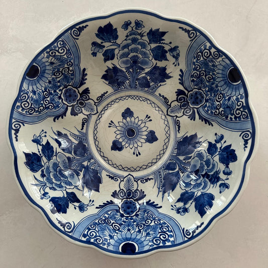 Decorative ceramic plate with blue floral patterns on a white background