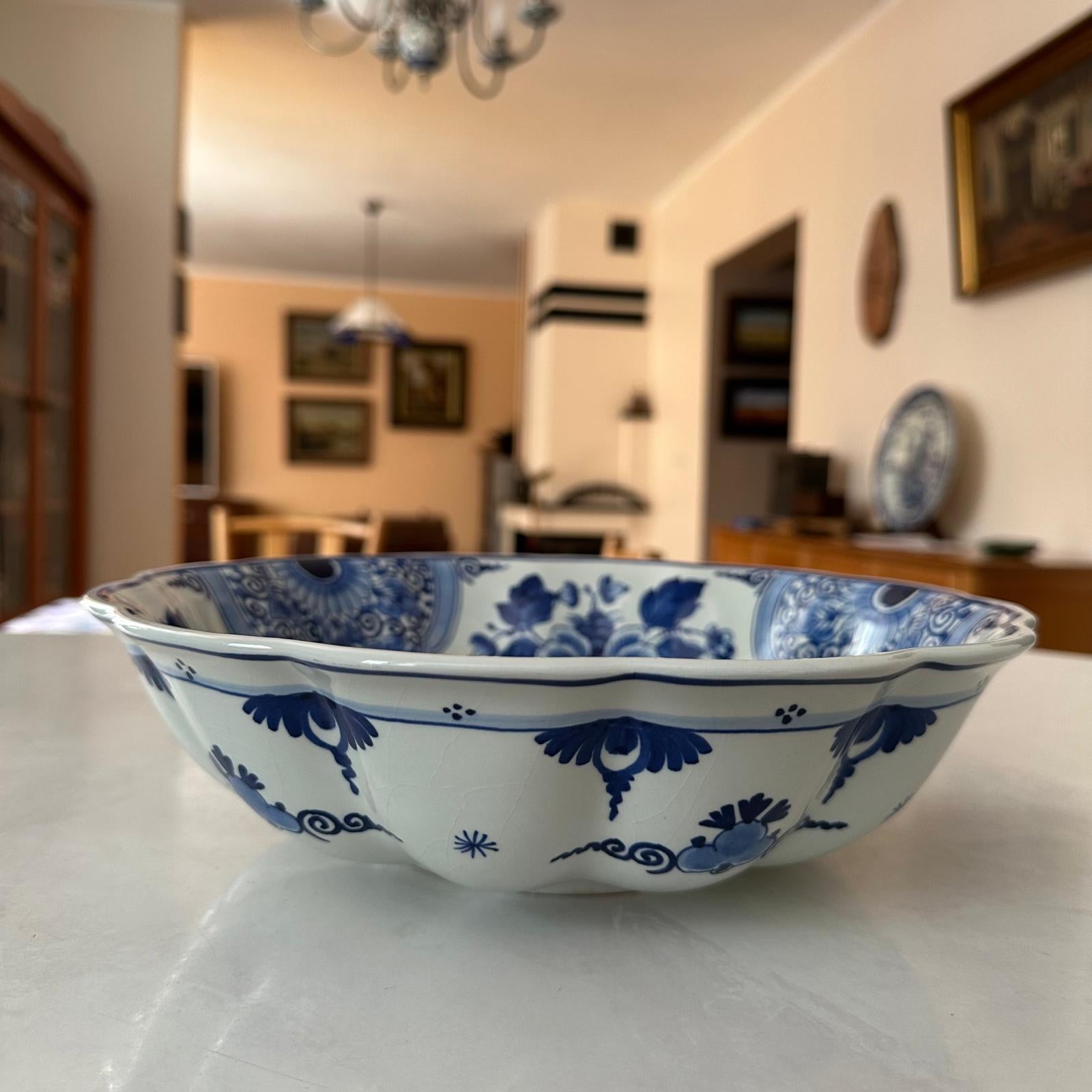 Blue and white ceramic bowl on a table with a blurred indoor setting